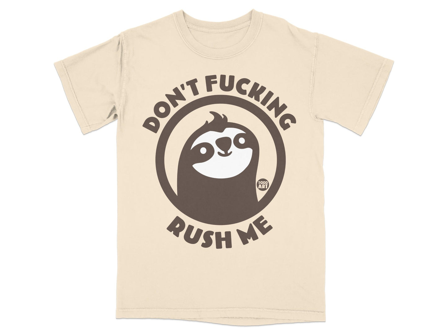 Cream t-shirt with a dark brown circular graphic of a sloth and the text "DON'T FUCKING RUSH ME".