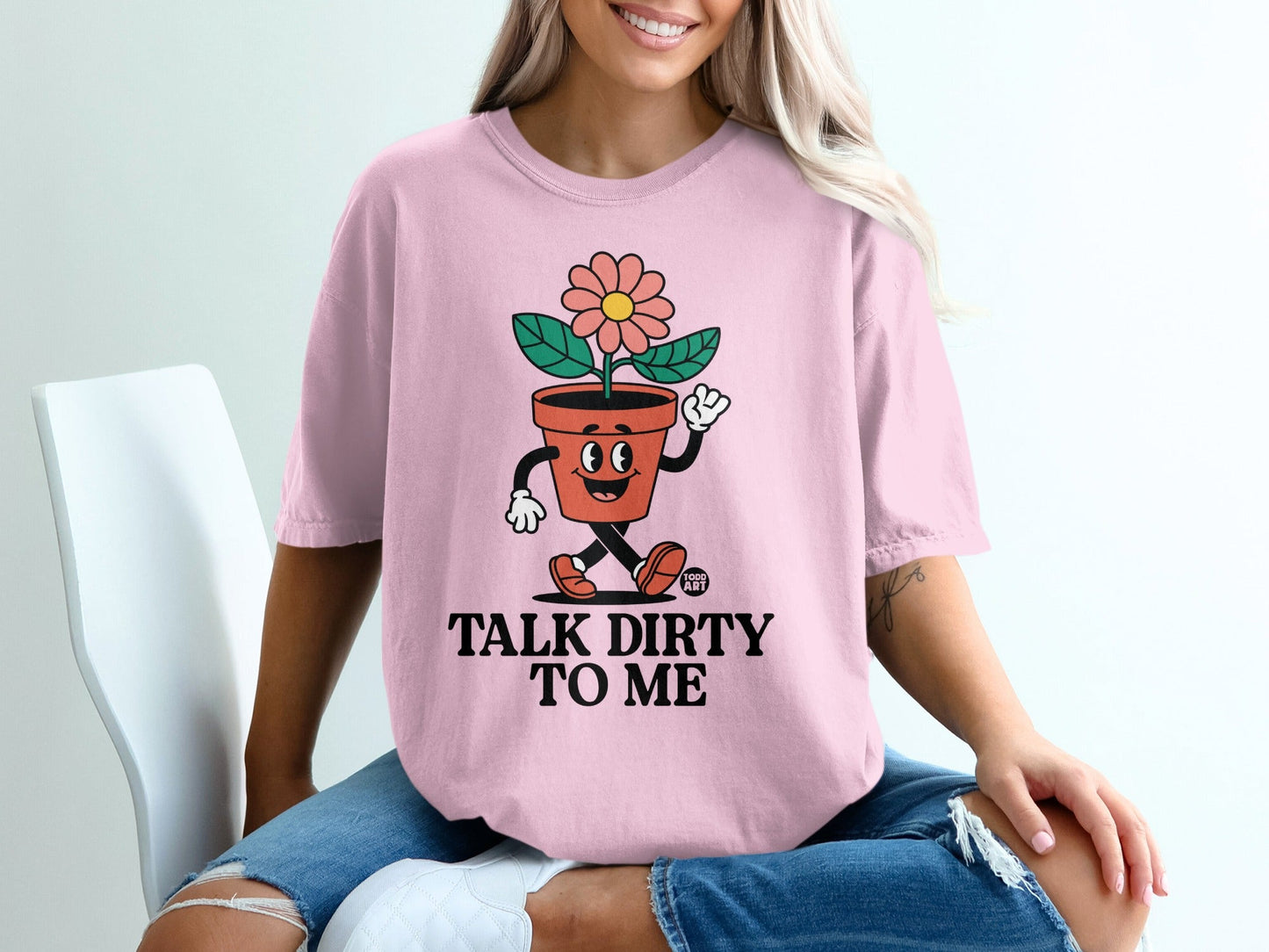 Pink t-shirt with cartoon flowerpot that says "TALK DIRTY TO ME".