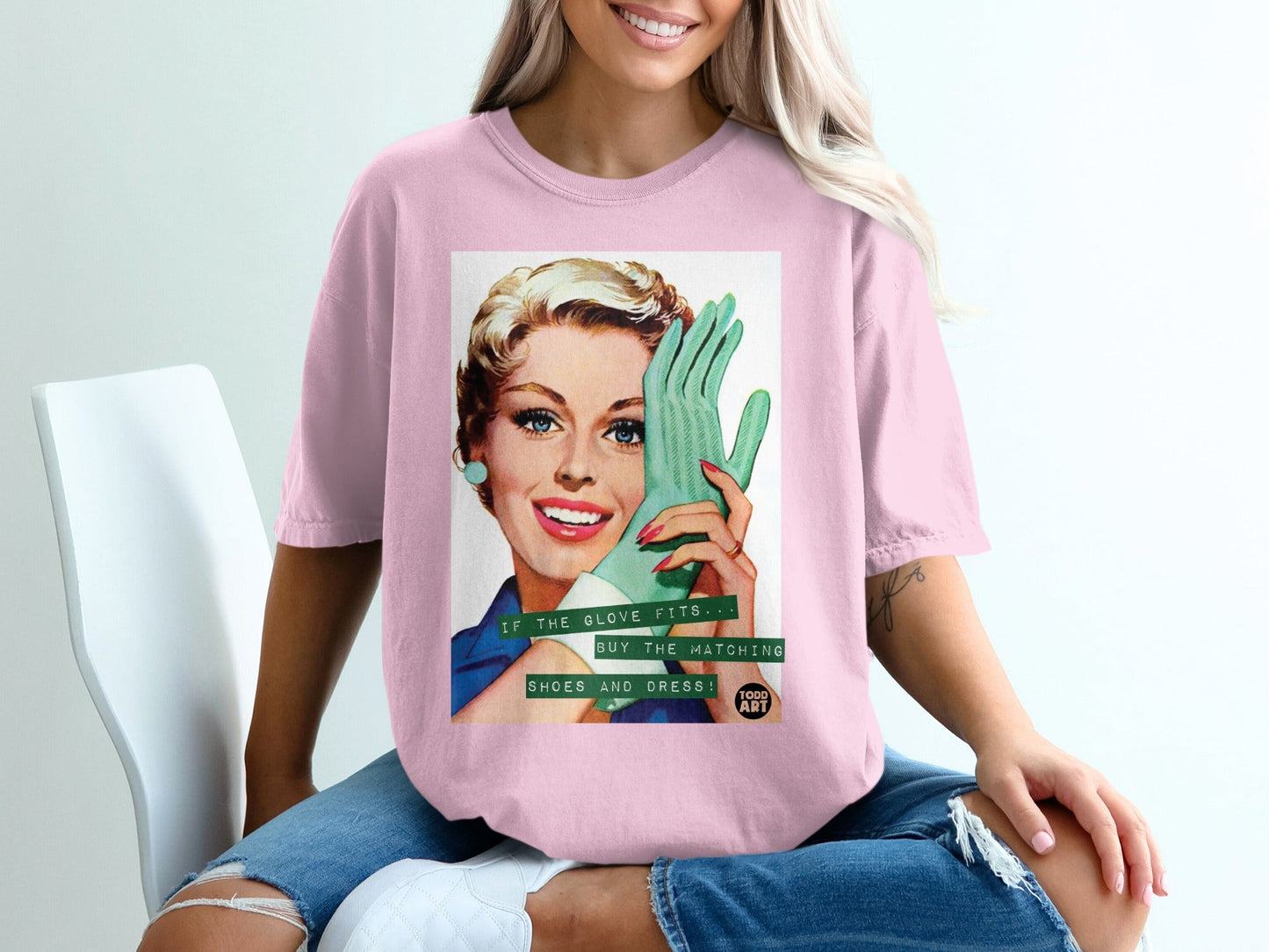 Woman in pink t-shirt holding green glove with text "IF THE GLOVE FITS... BUY THE MATCHING SHOES AND DRESS!".