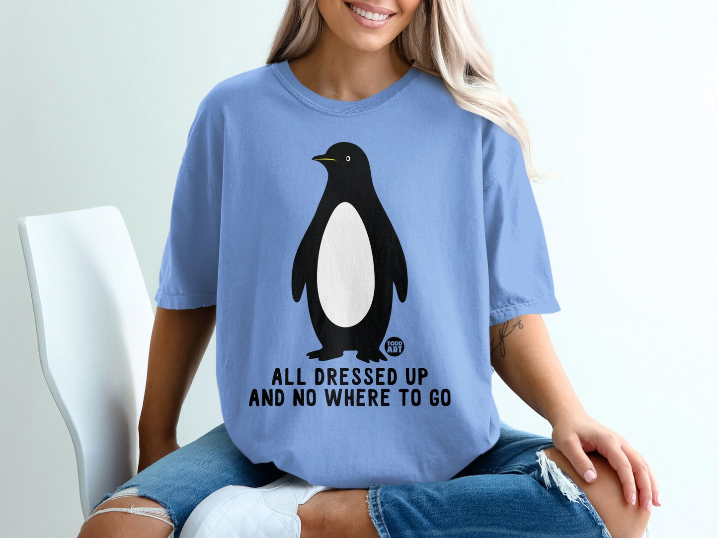 Blue t-shirt with penguin graphic and "All Dressed Up And No Where To Go" text.