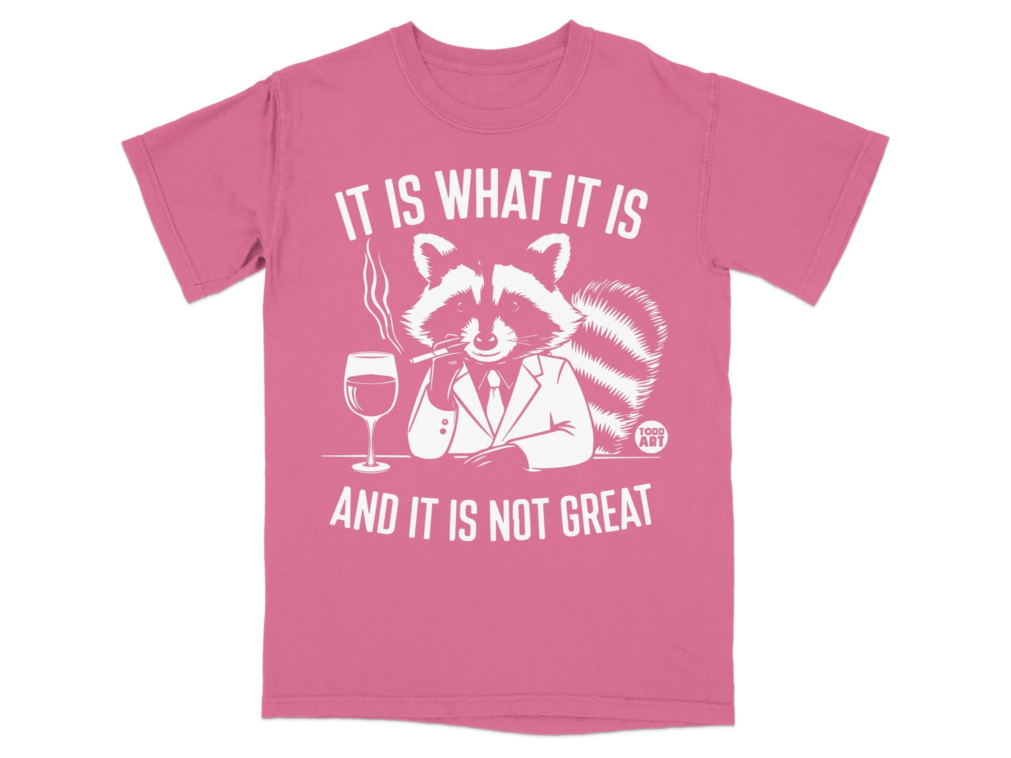 Pink t-shirt with a smoking raccoon in a suit saying "It is what it is and it is not great."