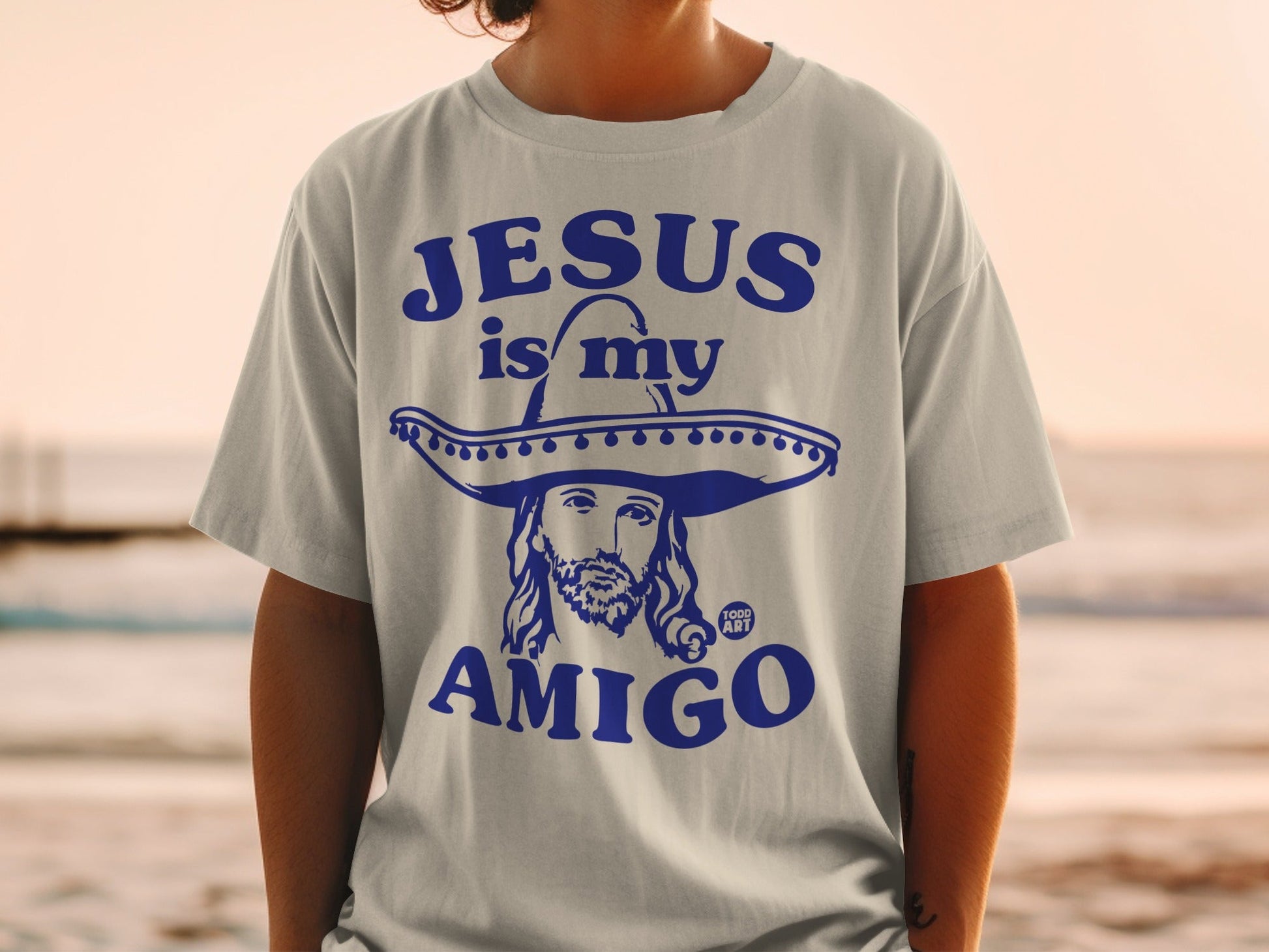 Blue t-shirt with "Jesus is my Amigo" text and Jesus wearing a sombrero.