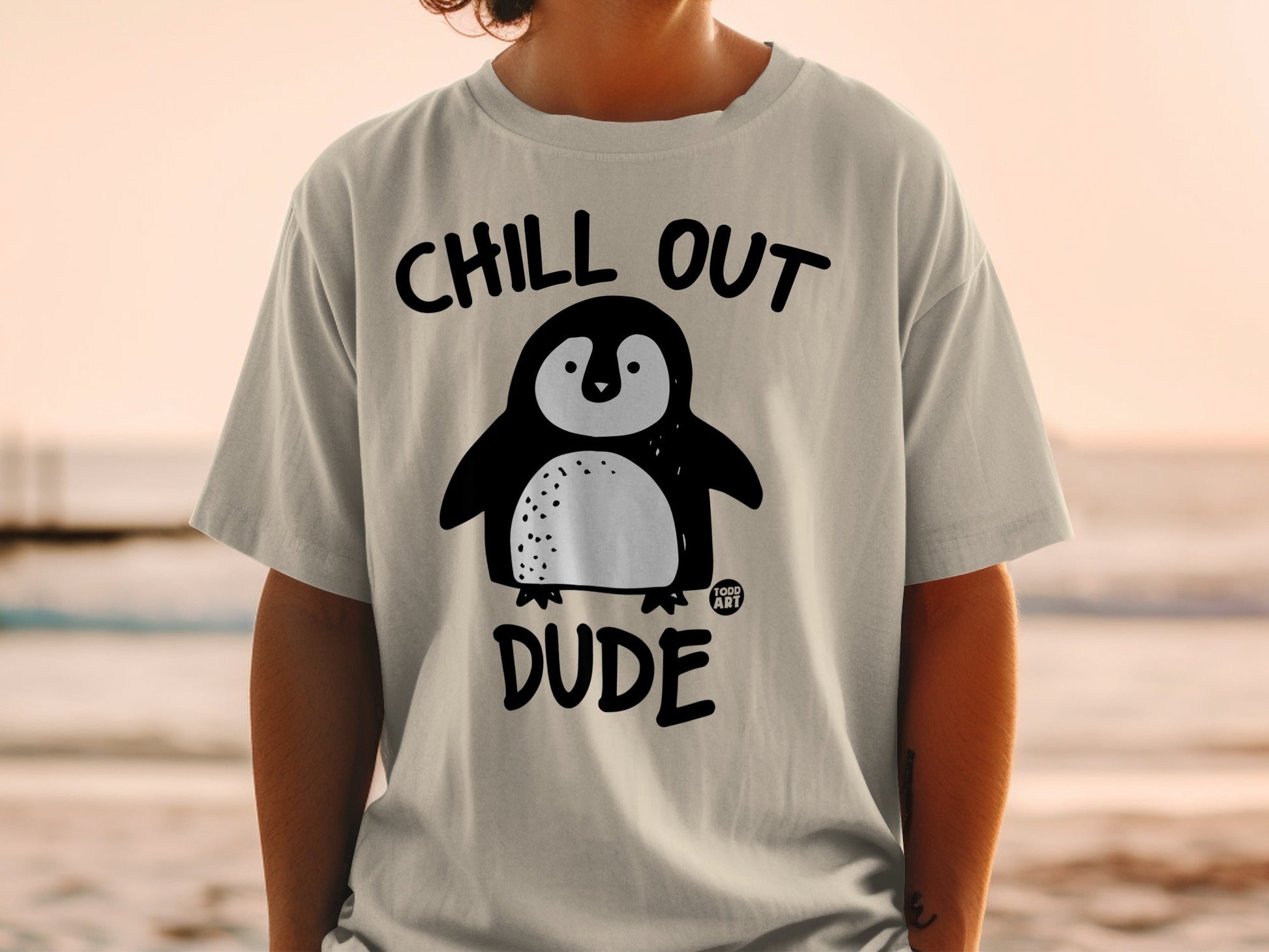 T-shirt with "Chill Out Dude" text and a cartoon penguin graphic.