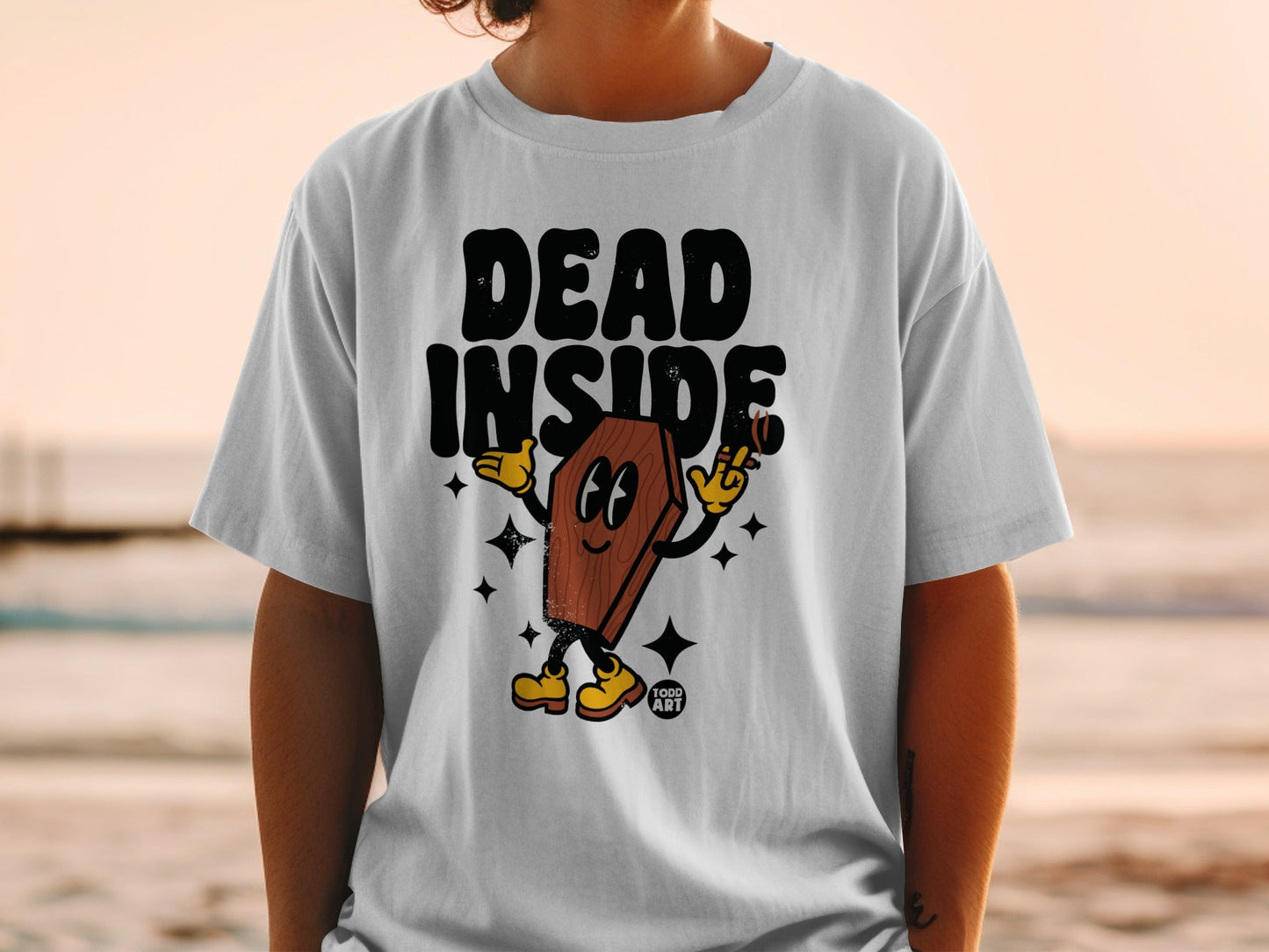 T-shirt with cartoon coffin character and text "DEAD INSIDE" and "TODD ART".