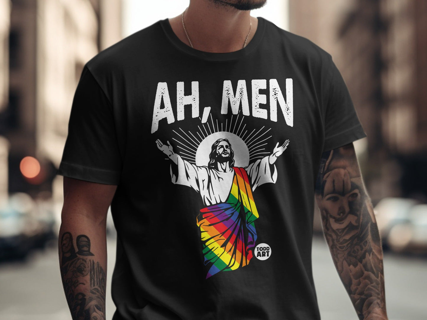 Black t-shirt with Jesus wearing a rainbow robe and text "AH, MEN".
