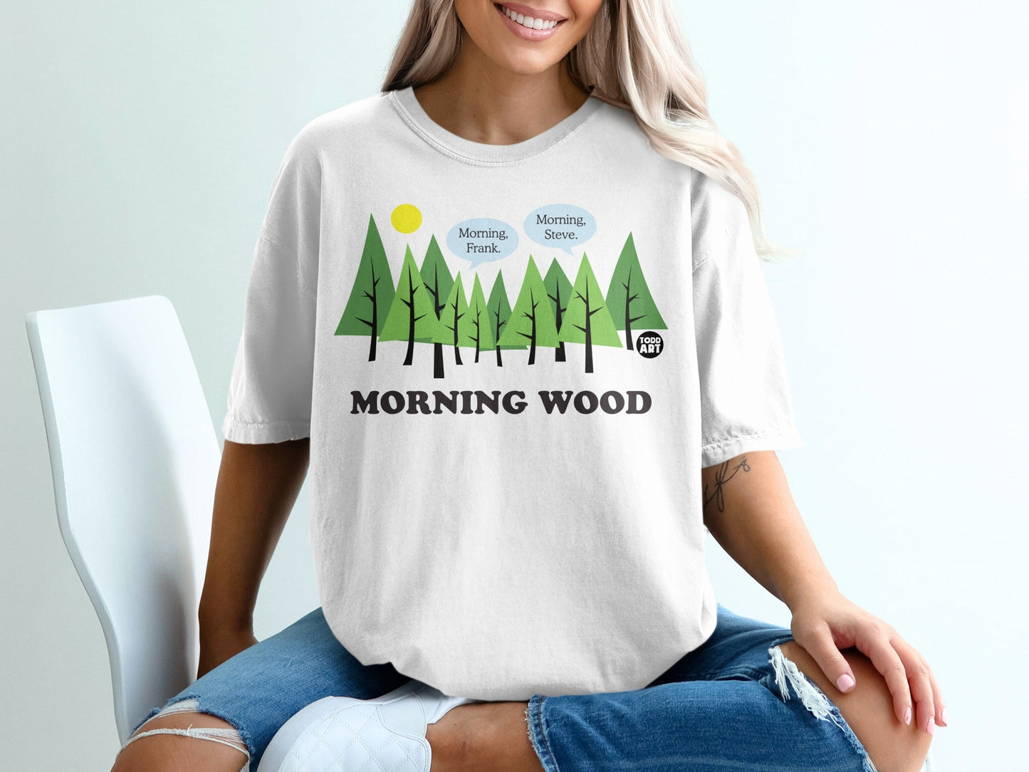 White t-shirt with green trees and text "Morning Wood" and speech bubbles.