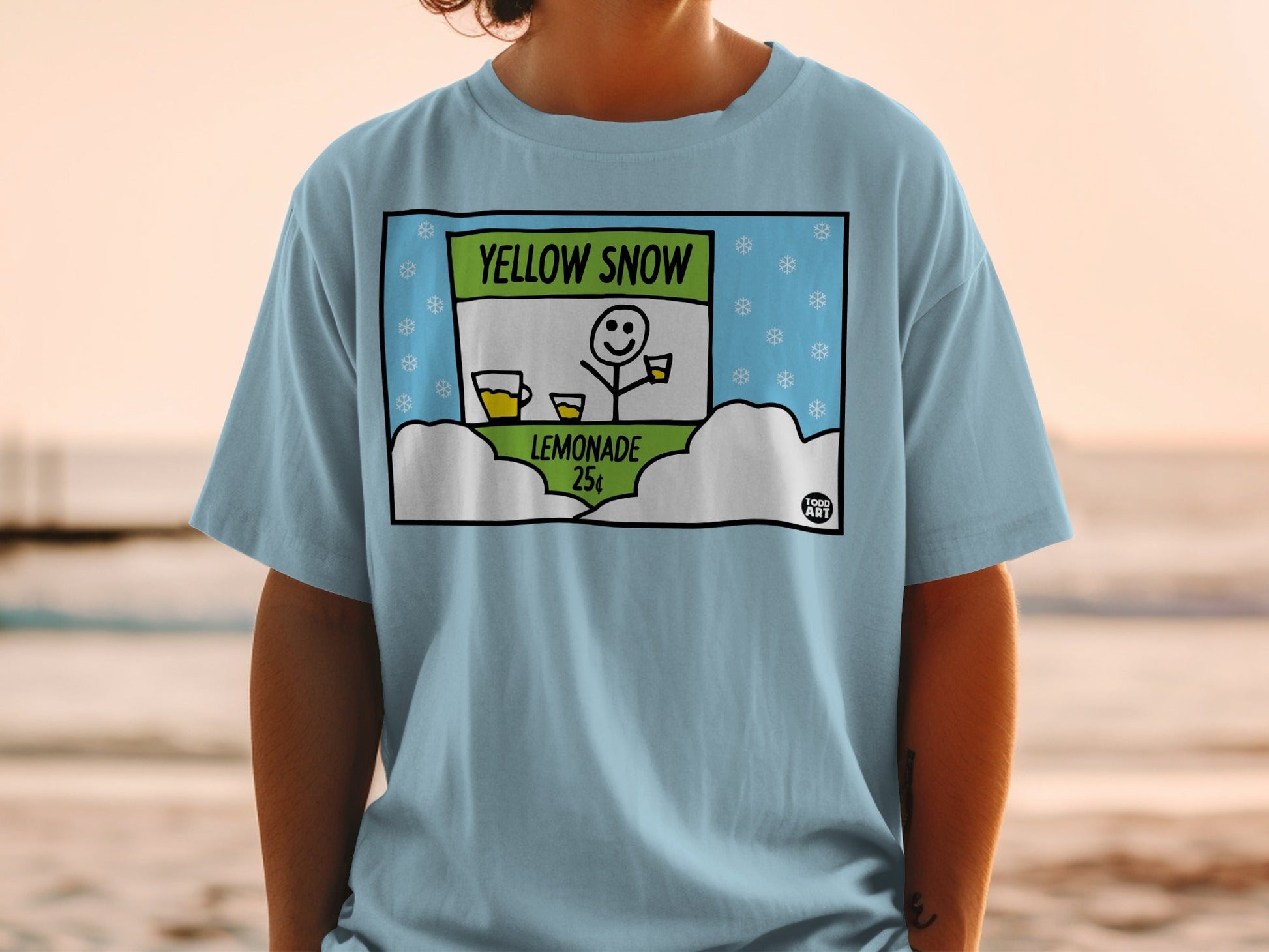 Light blue t-shirt with a cartoon of a snowman selling lemonade for 25 cents.