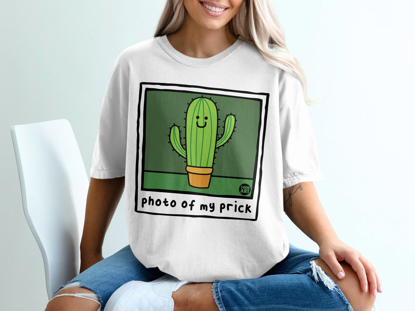 Cartoon cactus wearing sunglasses on a white t-shirt.