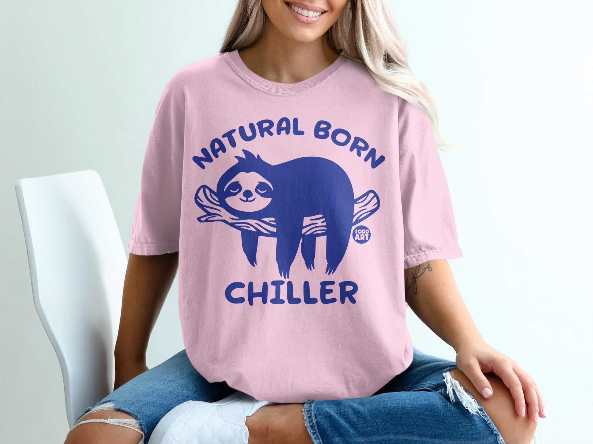Pink t-shirt with blue sloth graphic and text "NATURAL BORN CHILLER".