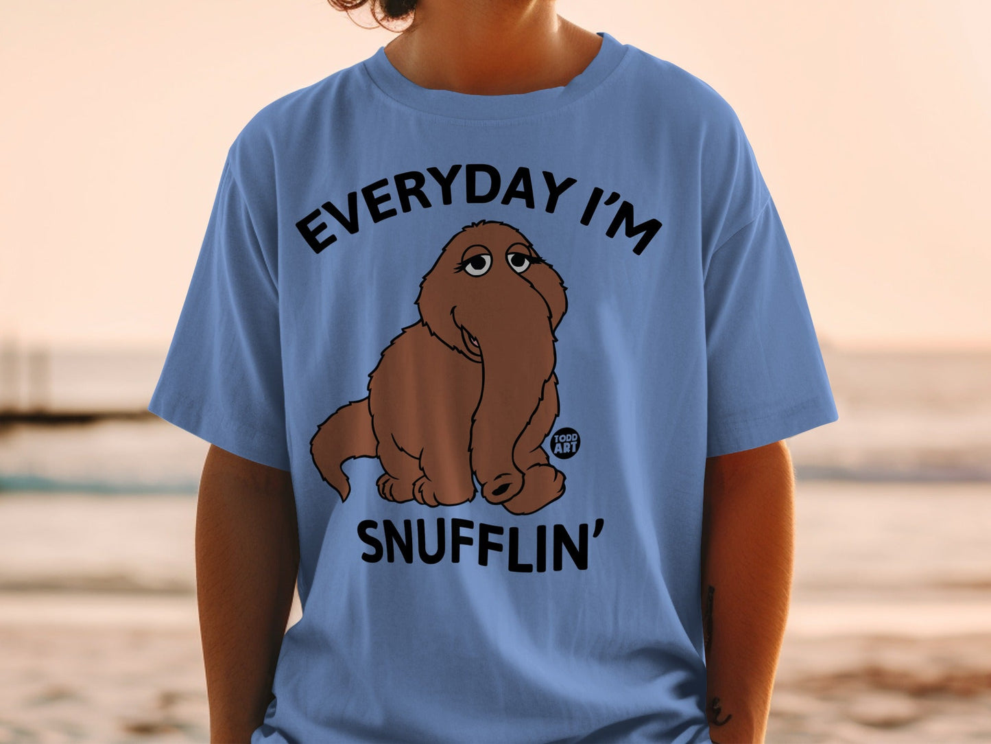 Blue t-shirt with text "EVERYDAY I'M SNUFFLIN'" and a cartoon brown creature.