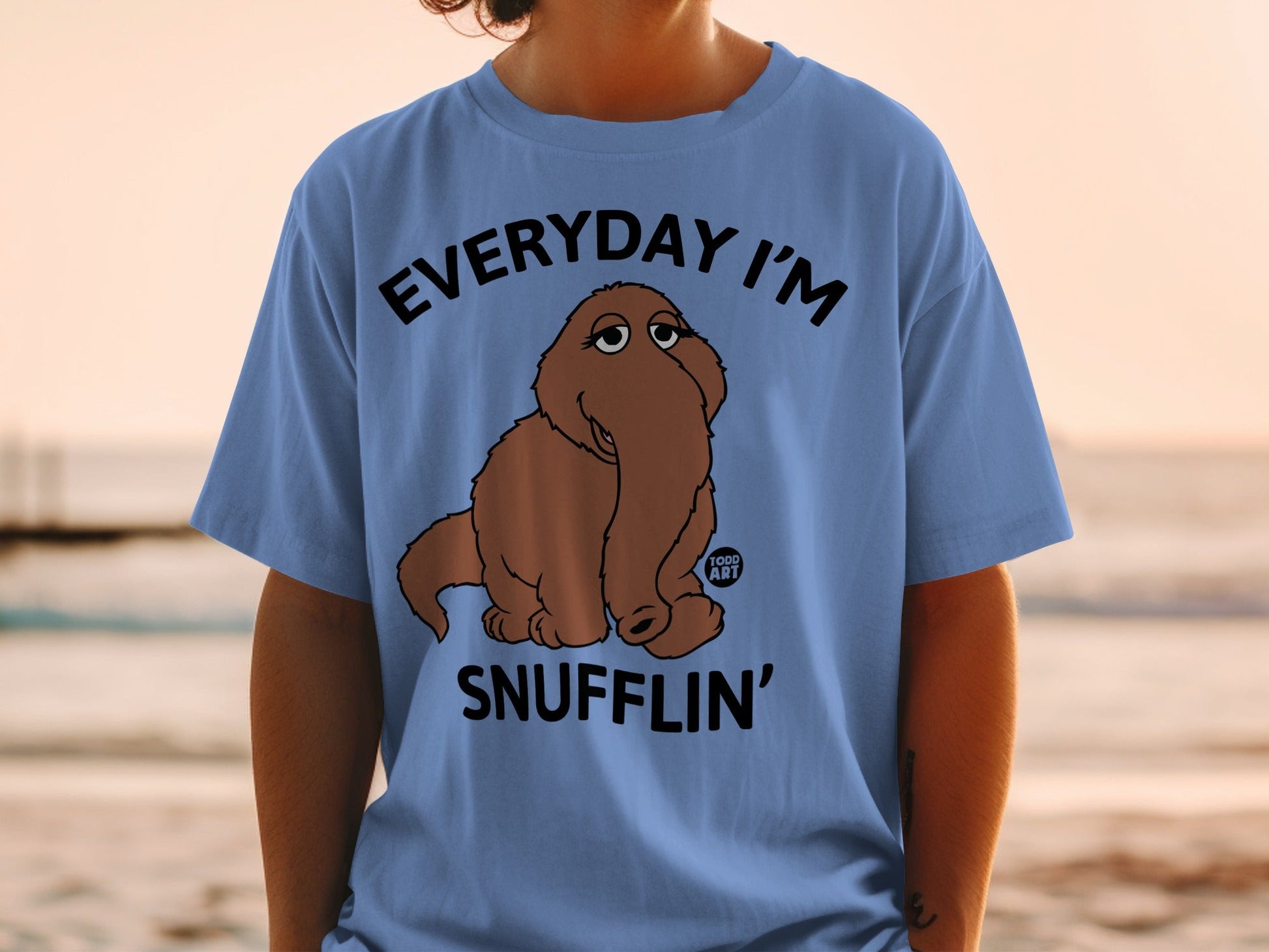 Blue t-shirt with text "EVERYDAY I'M SNUFFLIN'" and a cartoon brown creature.