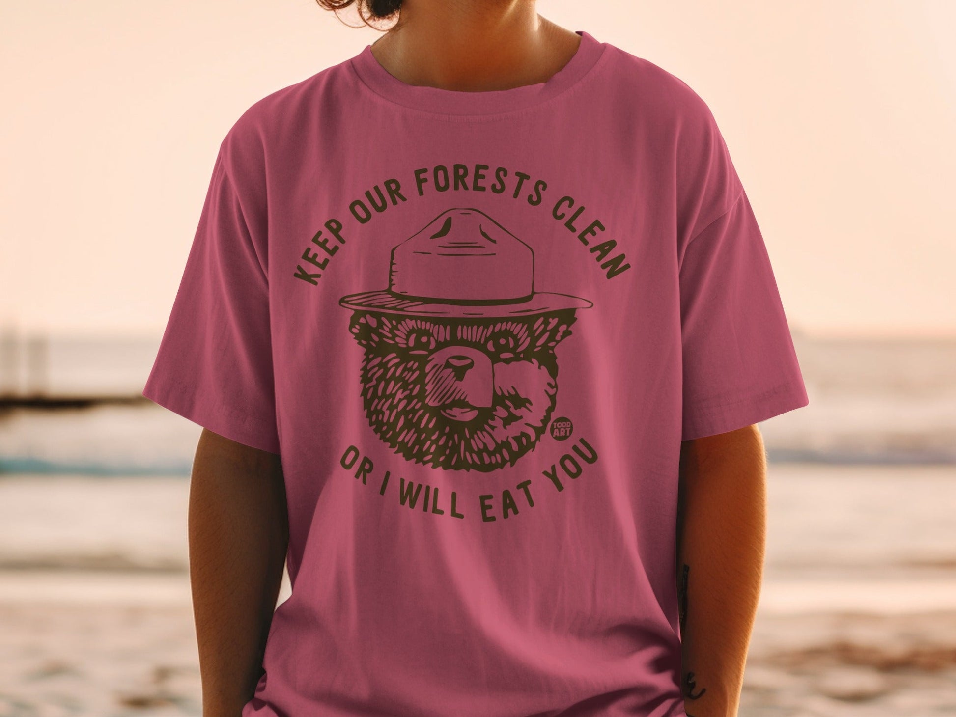 Smokey Bear wearing a hat and the text "Keep Our Forests Clean or I Will Eat You".