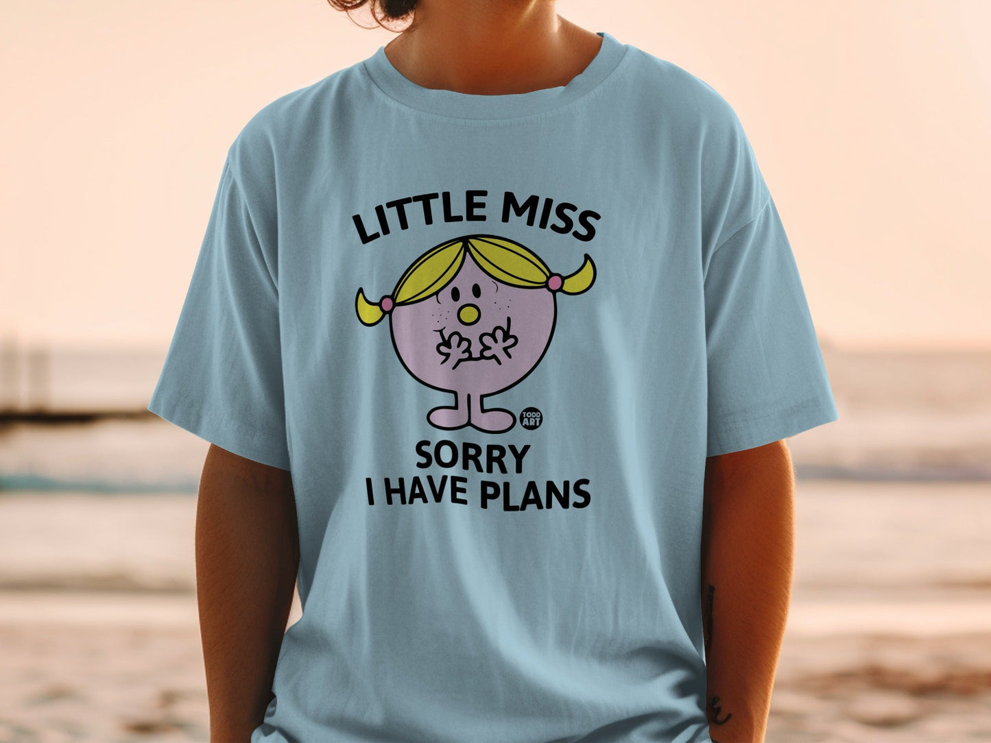 Light blue t-shirt with "Little Miss Sorry I Have Plans" text and cartoon character.