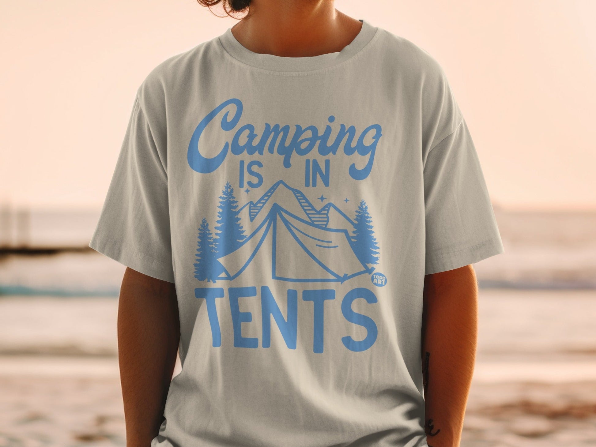 Light blue t-shirt with "Camping is in Tents" graphic and camping scene.