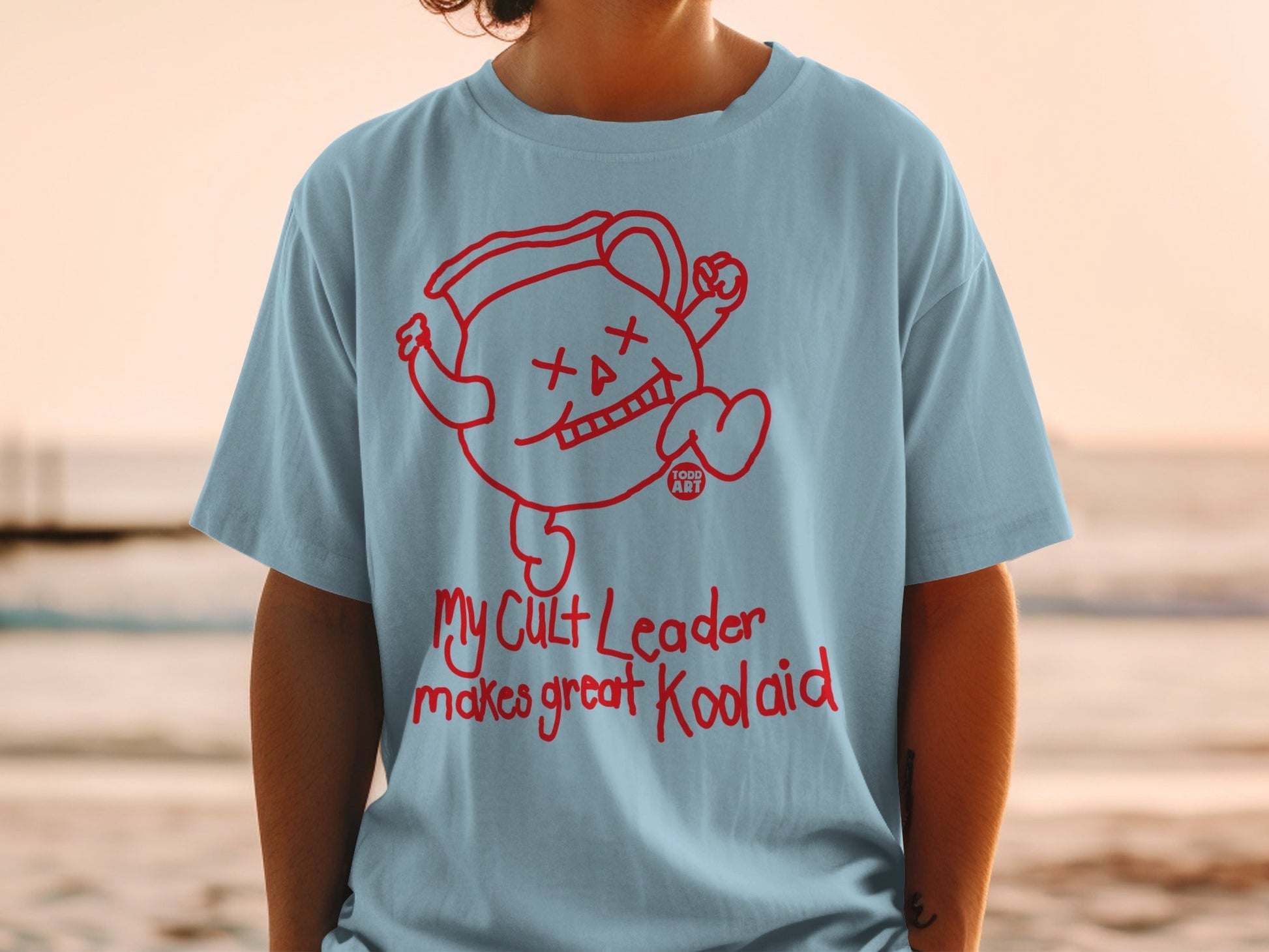 Light blue t-shirt featuring Kool-Aid Man graphic and "My Cult Leader makes great Kool-Aid" text.