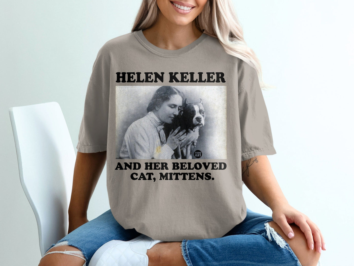 T-shirt with "Helen Keller and Her Beloved Cat, Mittens" text and vintage portrait.