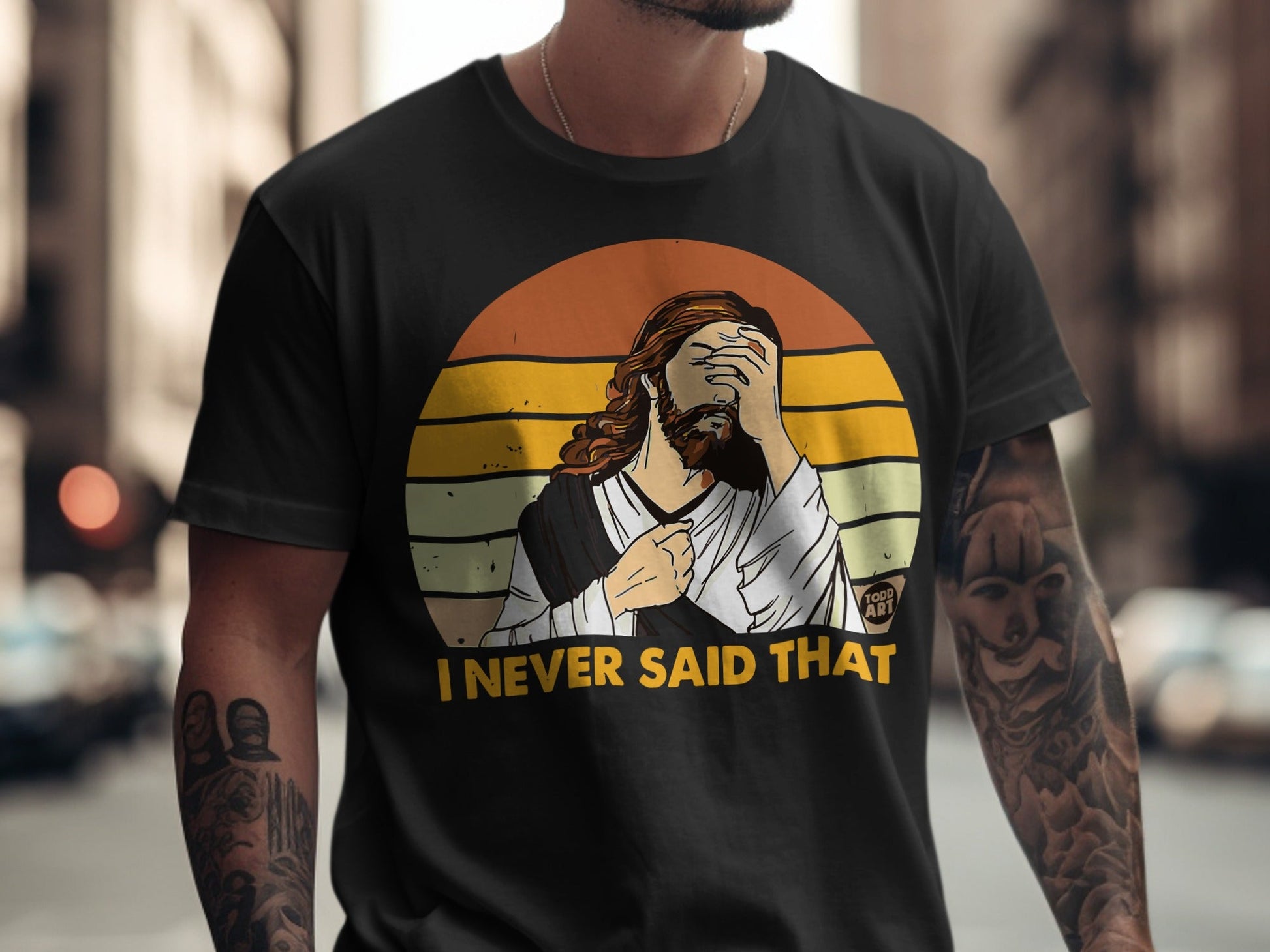 Black t-shirt with graphic of Jesus covering face and text "I NEVER SAID THAT."