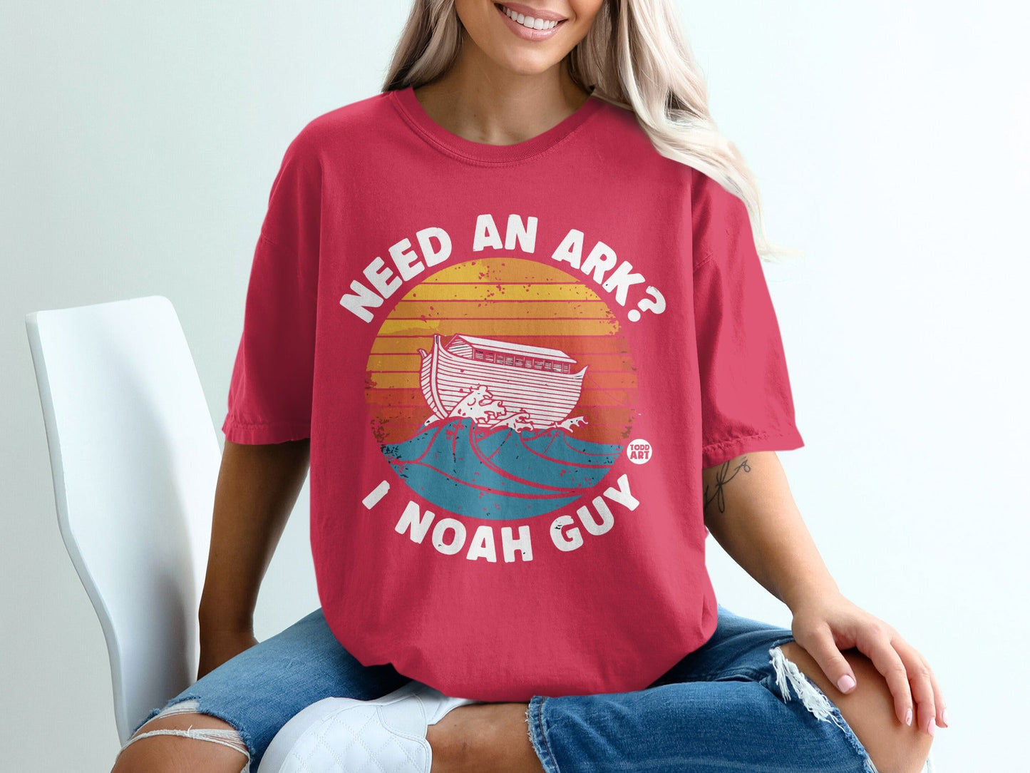 Red t-shirt with "NEED AN ARK? I NOAH GUY" and an ark on waves.