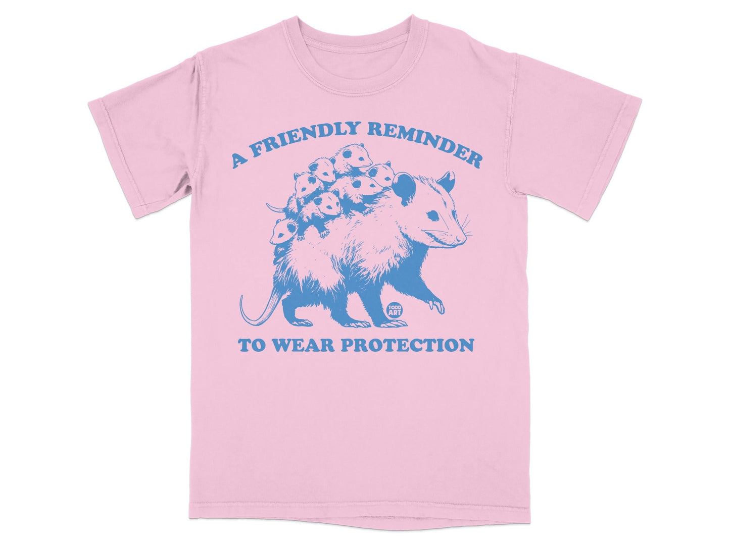 Pink t-shirt with a blue graphic of an opossum carrying babies and text.