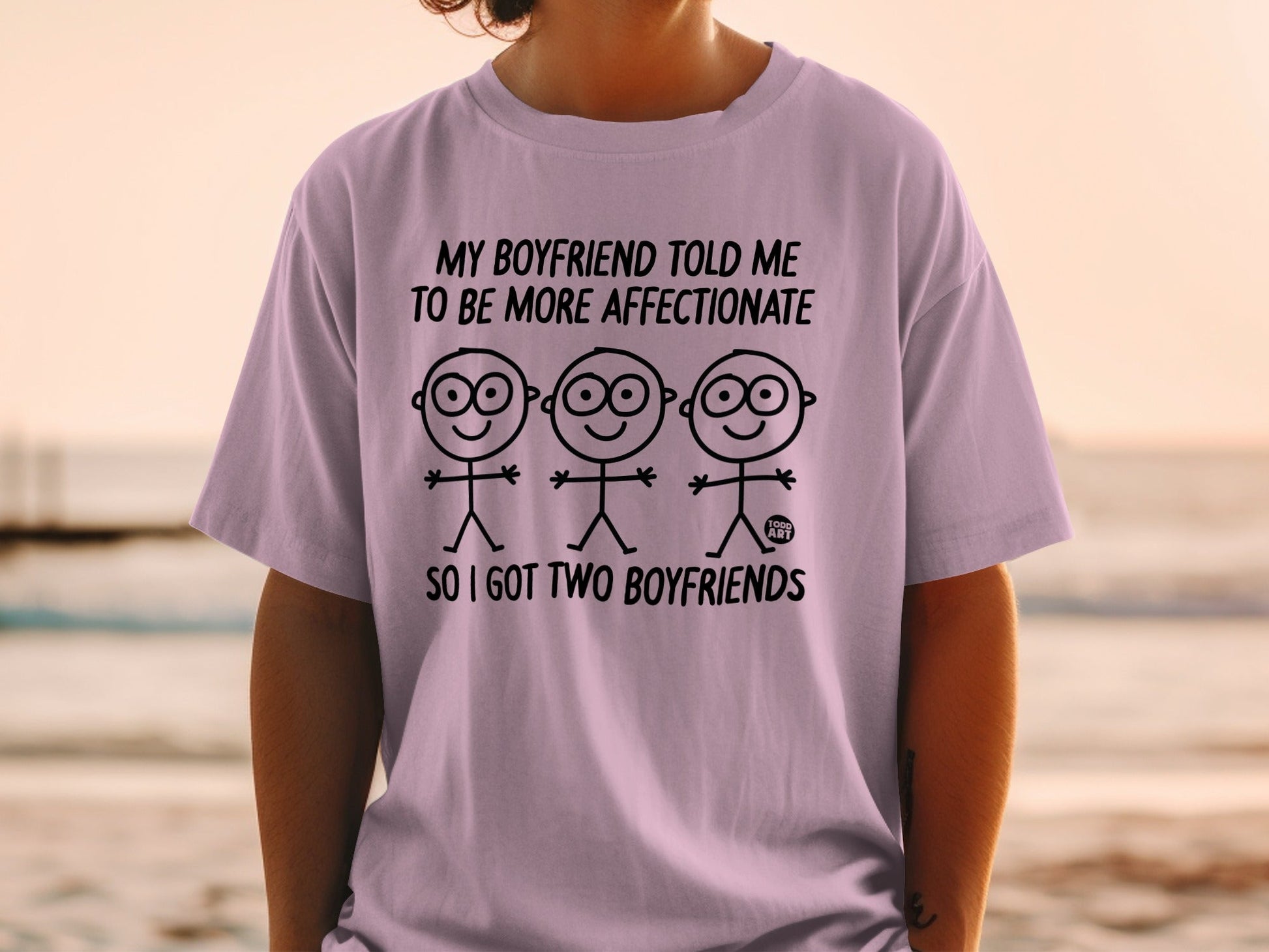 T-shirt with stick figures and text: "My boyfriend told me to be more affectionate, so I got two boyfriends."