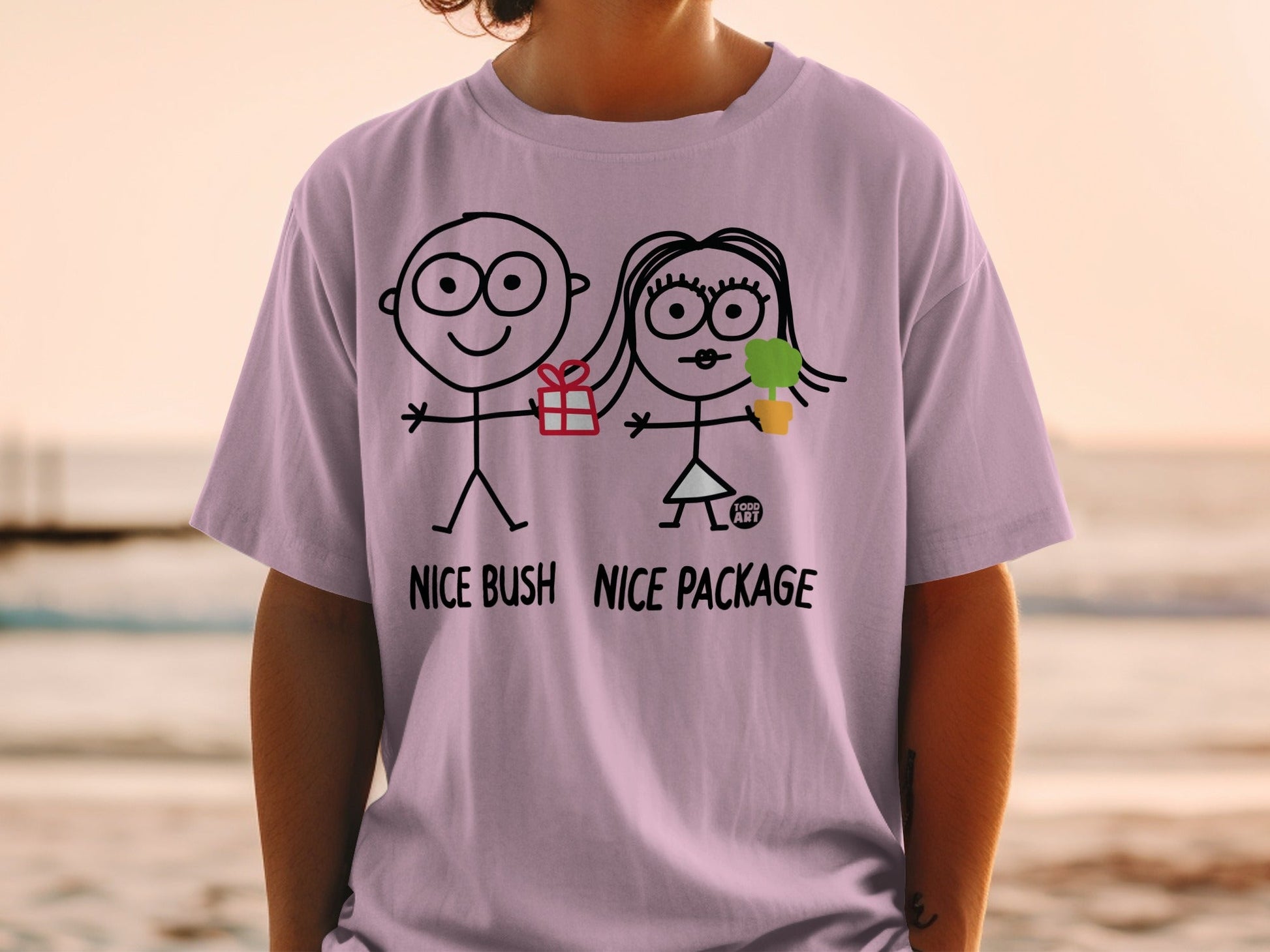 T-shirt with stick figures, gift, and plant, reading "NICE BUSH NICE PACKAGE".