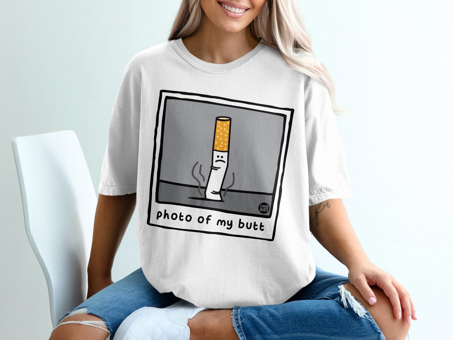 T-shirt with cartoon cigarette character saying "photo of my butt".