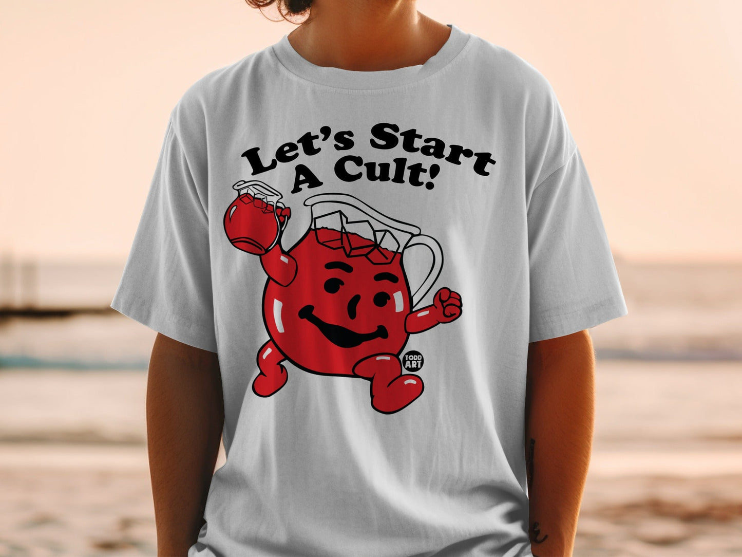 White t-shirt with Kool-Aid Man character and "Let's Start A Cult!" text.