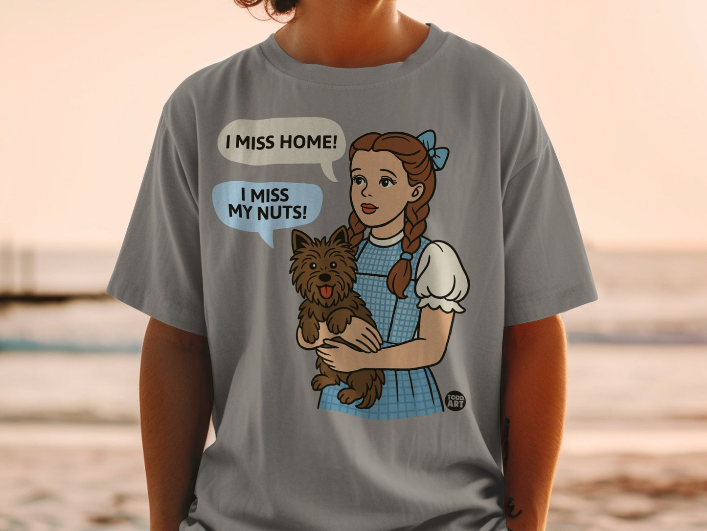 Dorothy from The Wizard of Oz holding Toto, saying "I miss home!".
