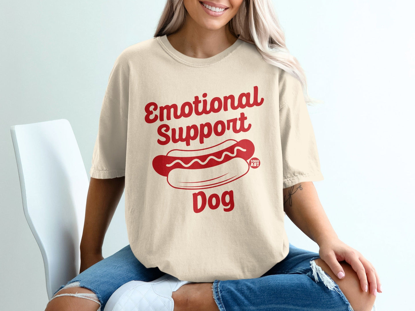Cream t-shirt with "Emotional Support Dog" and hot dog graphic.