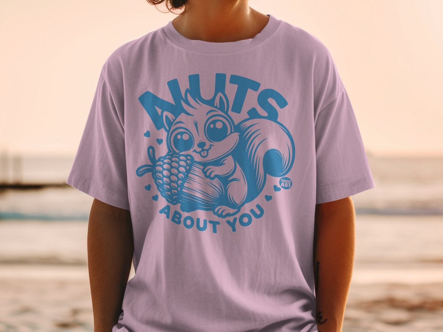 T-shirt with a cute squirrel holding a pinecone and text "nuts about you".