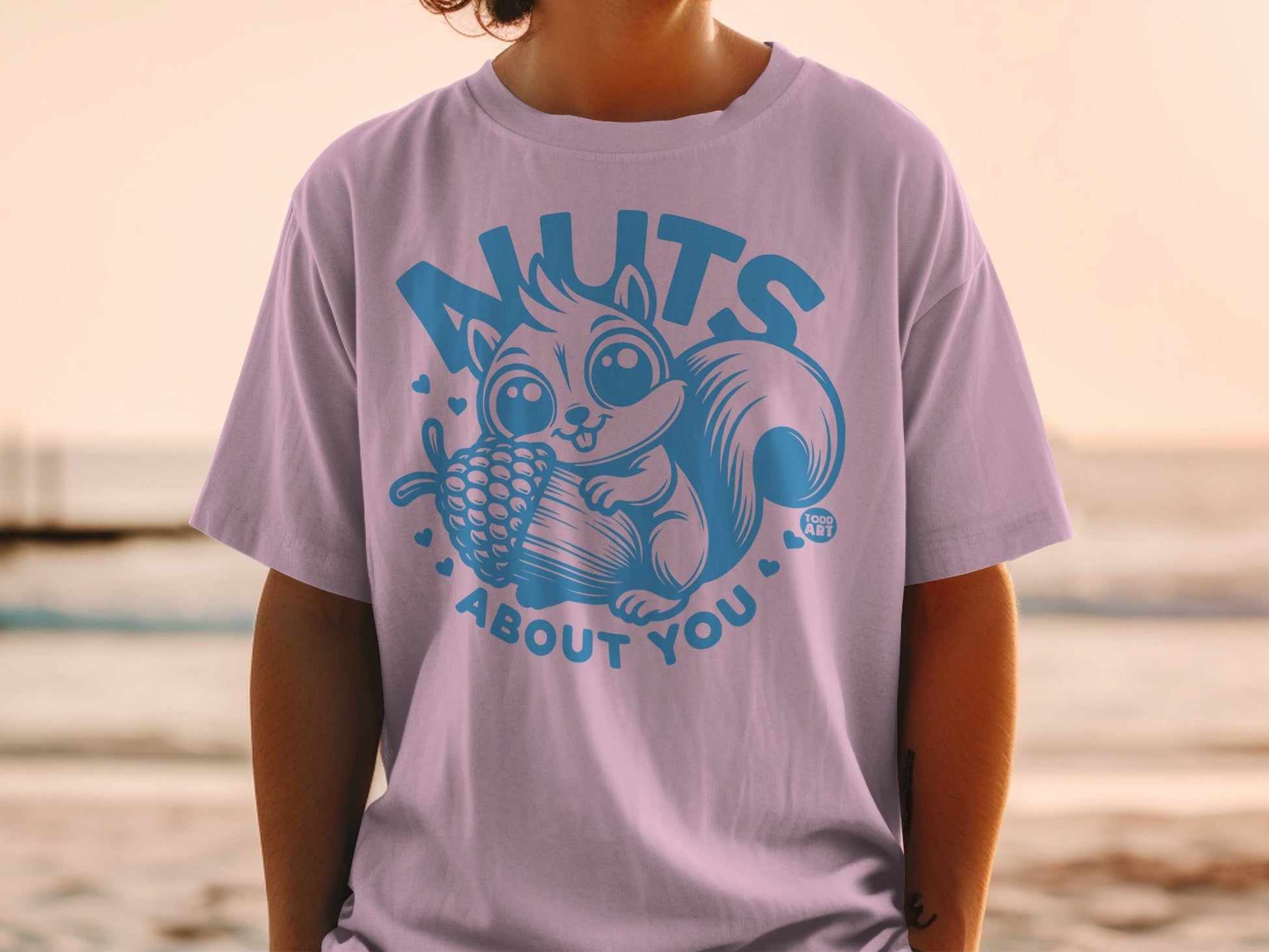 T-shirt with a cute squirrel holding a pinecone and text "nuts about you".