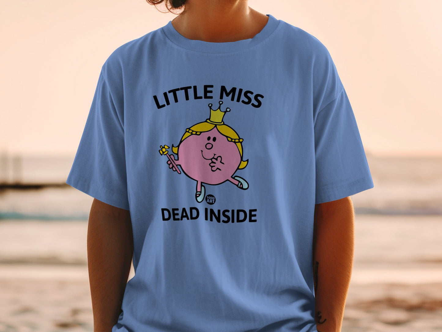 Light blue t-shirt with "Little Miss Dead Inside" text and cartoon graphic.