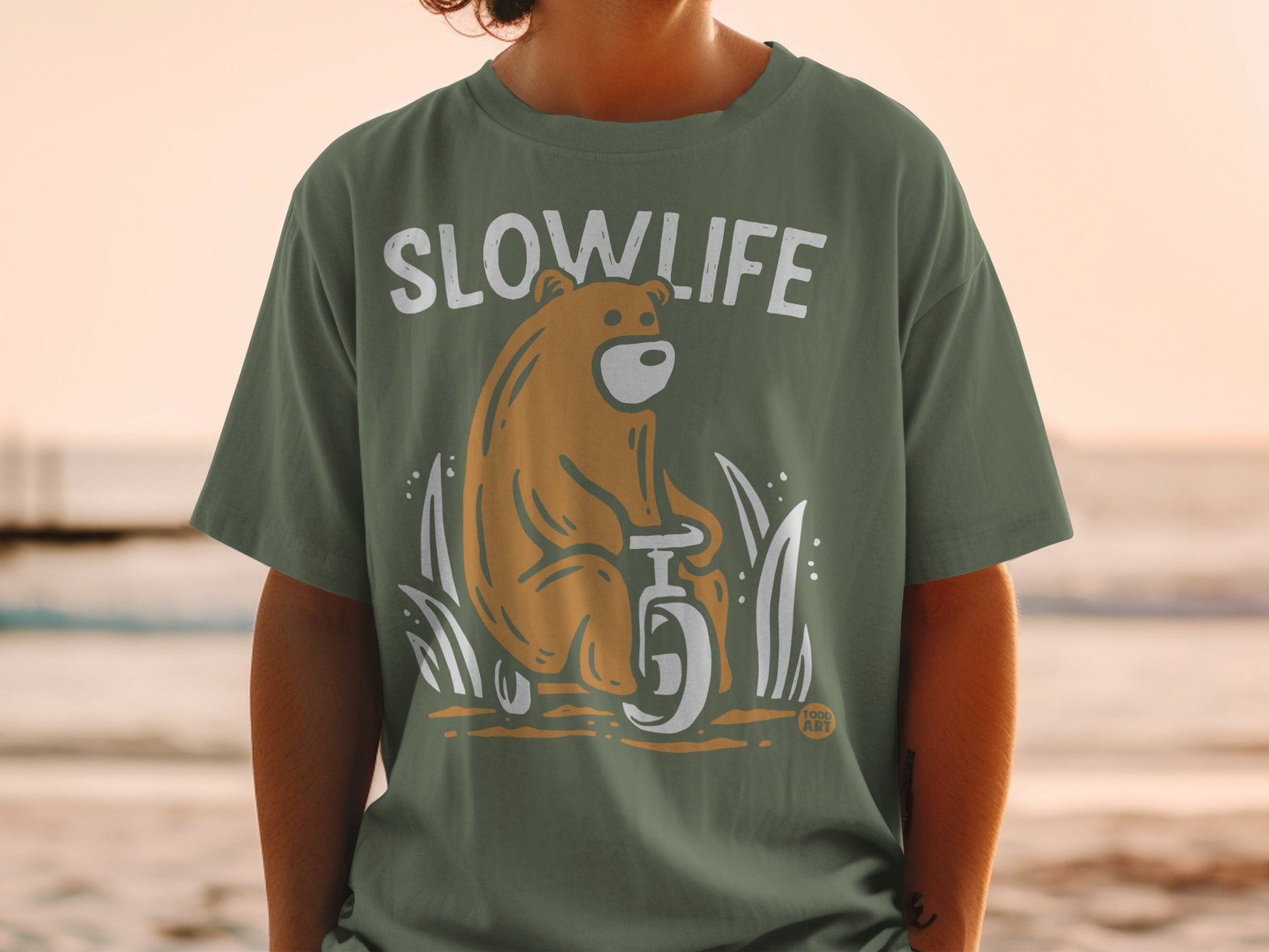 Slow Life Bear Graphic on Unicycle Green T-Shirt