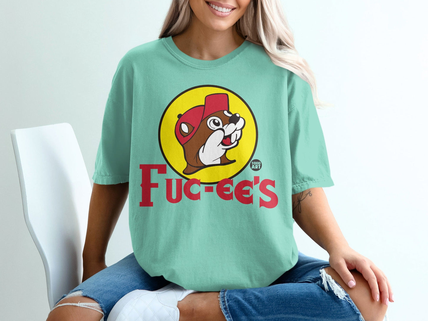Buc-ee's beaver logo on a mint green t-shirt.