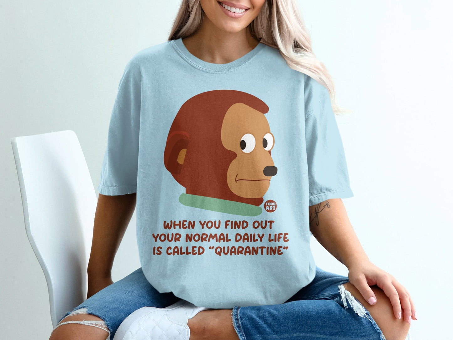 Light blue t-shirt with monkey looking surprised, text about quarantine.