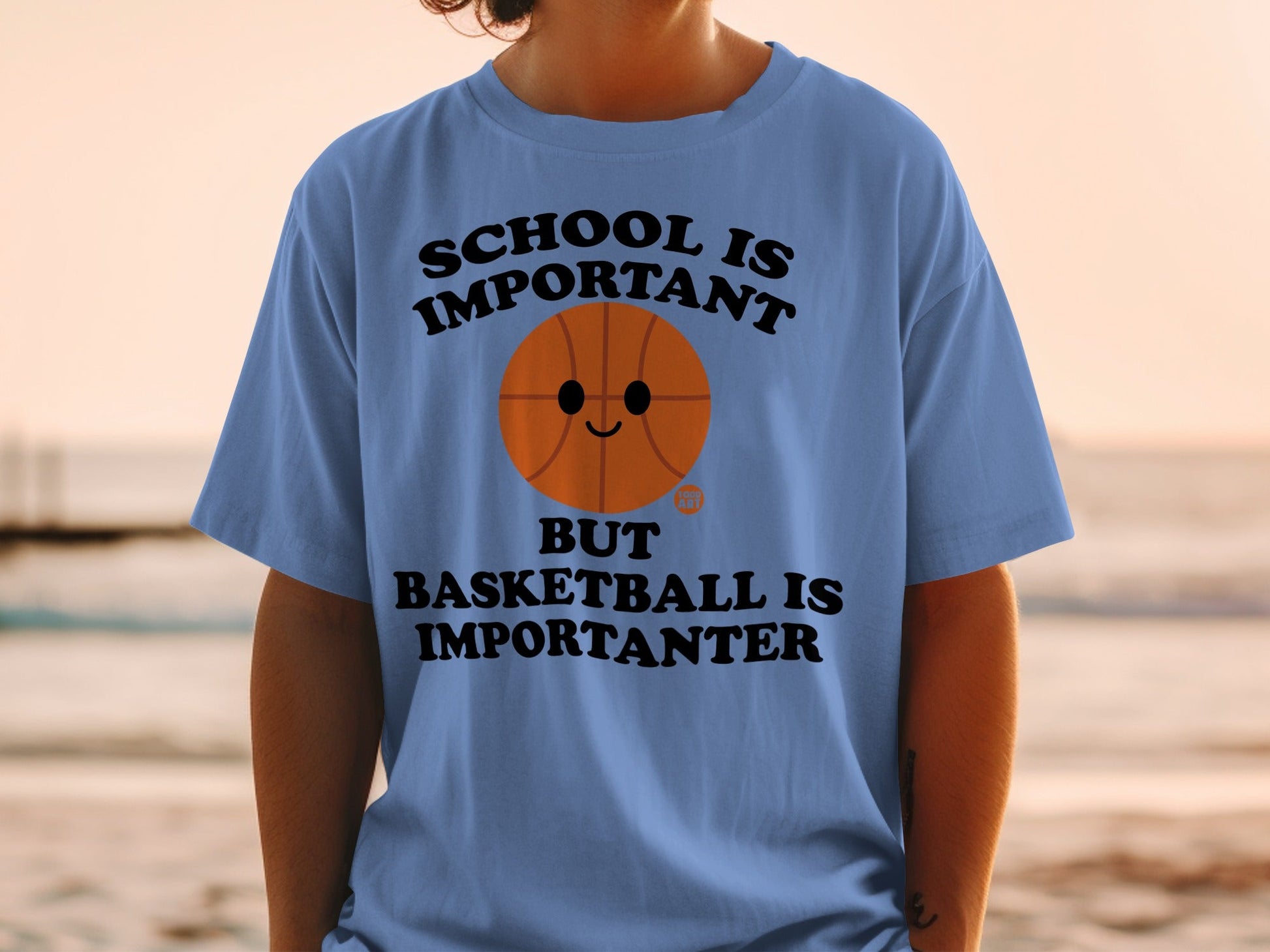 Blue t-shirt with a basketball graphic and text "SCHOOL IS IMPORTANT BUT BASKETBALL IS IMPORTANTER".