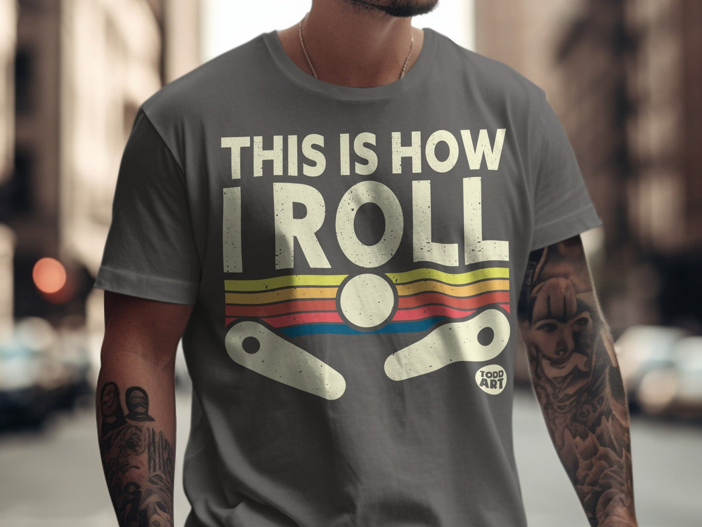 Grey t-shirt with "THIS IS HOW I ROLL" and a pinball graphic.