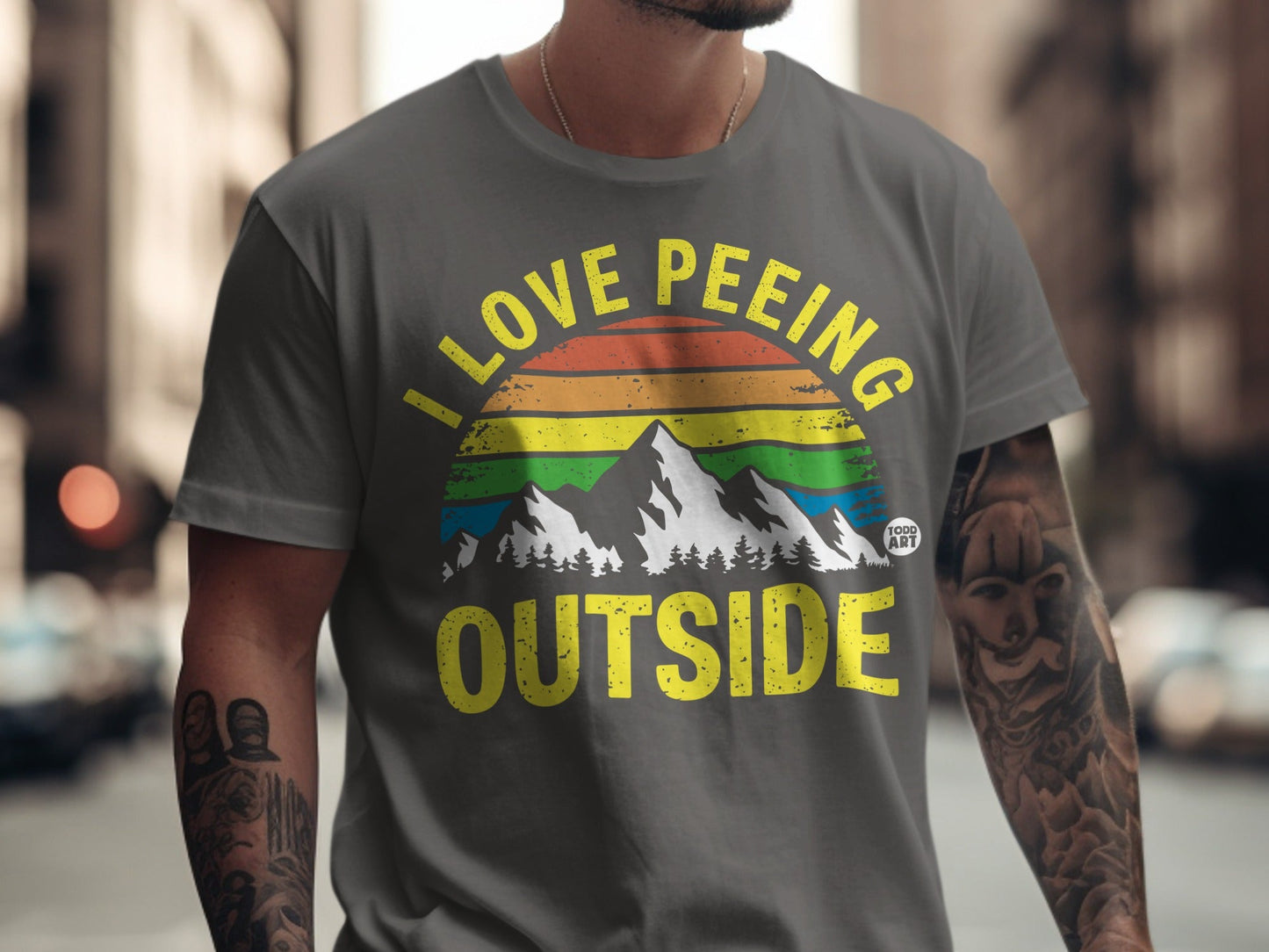 Gray t-shirt with "I Love Peeing Outside" text and rainbow mountain graphic.
