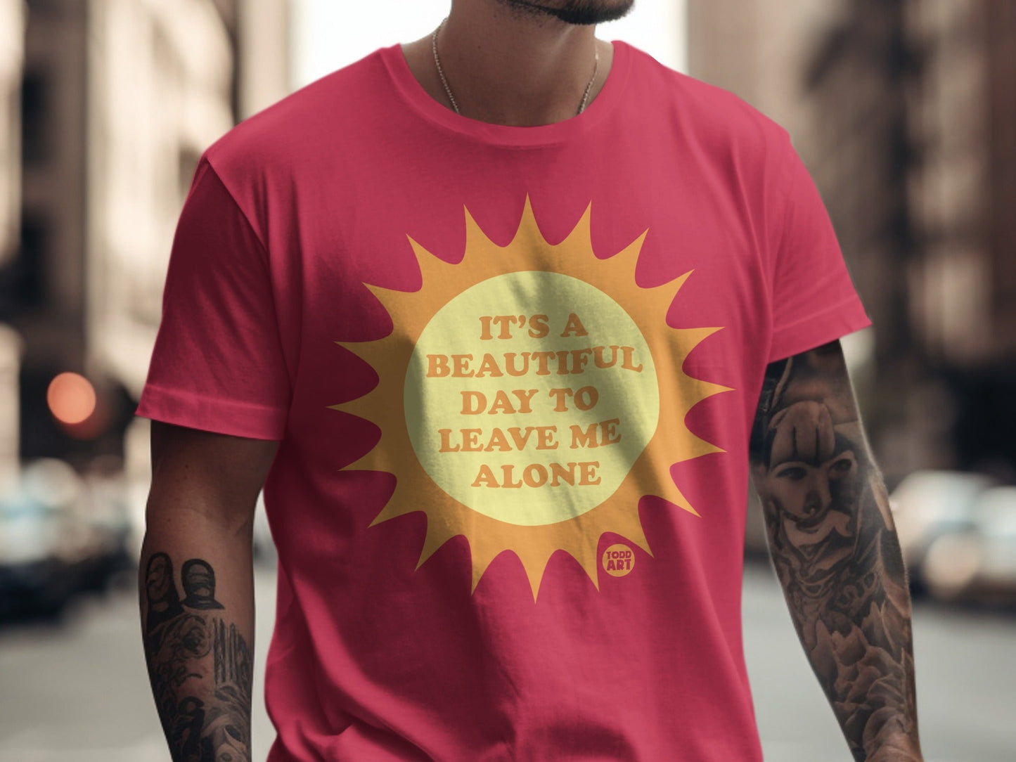 Crimson t-shirt with a yellow sun graphic and text that reads "It's a beautiful day to leave me alone".