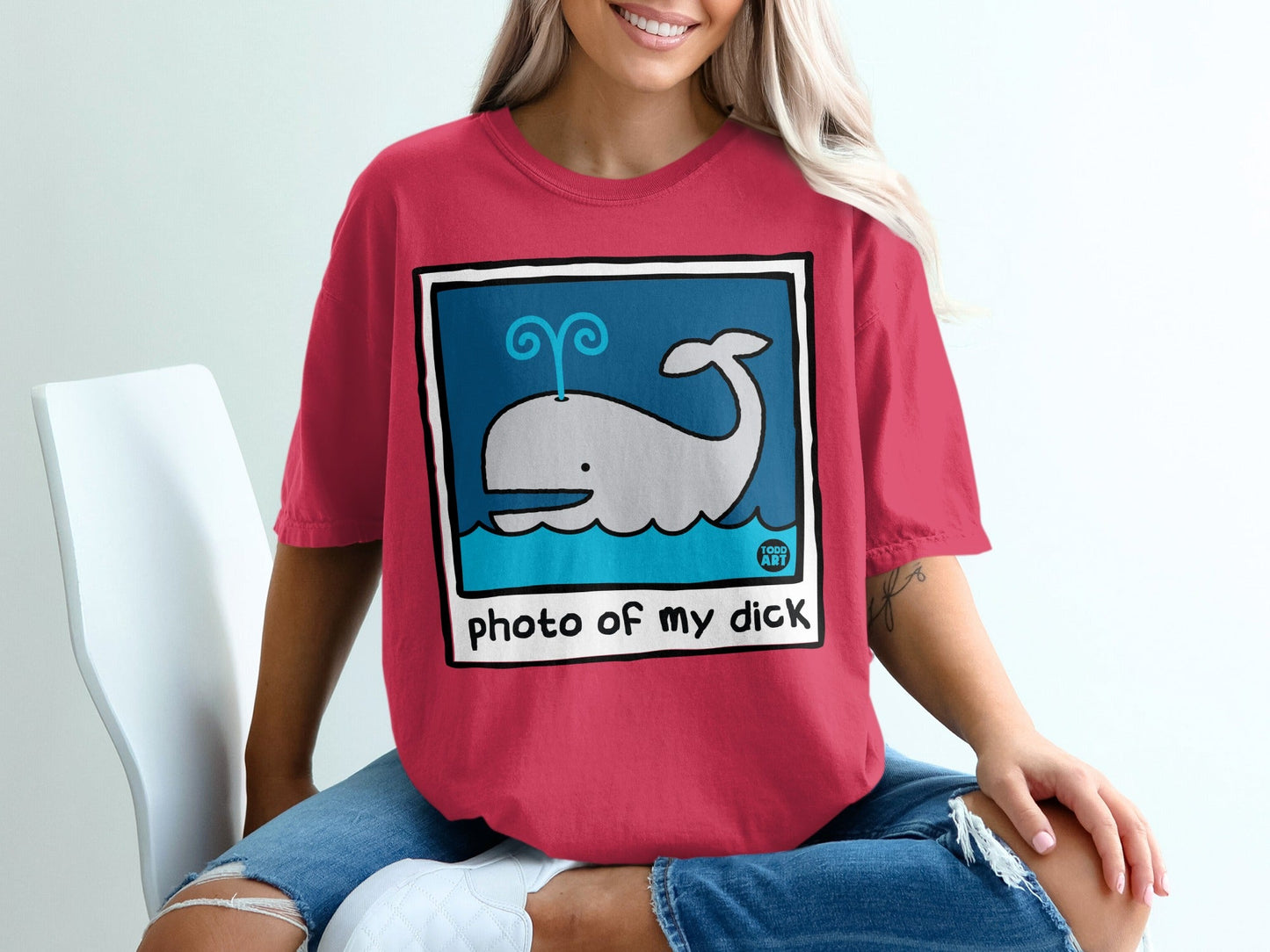 Red t-shirt with cartoon whale splashing water, text "photo of my dick"
