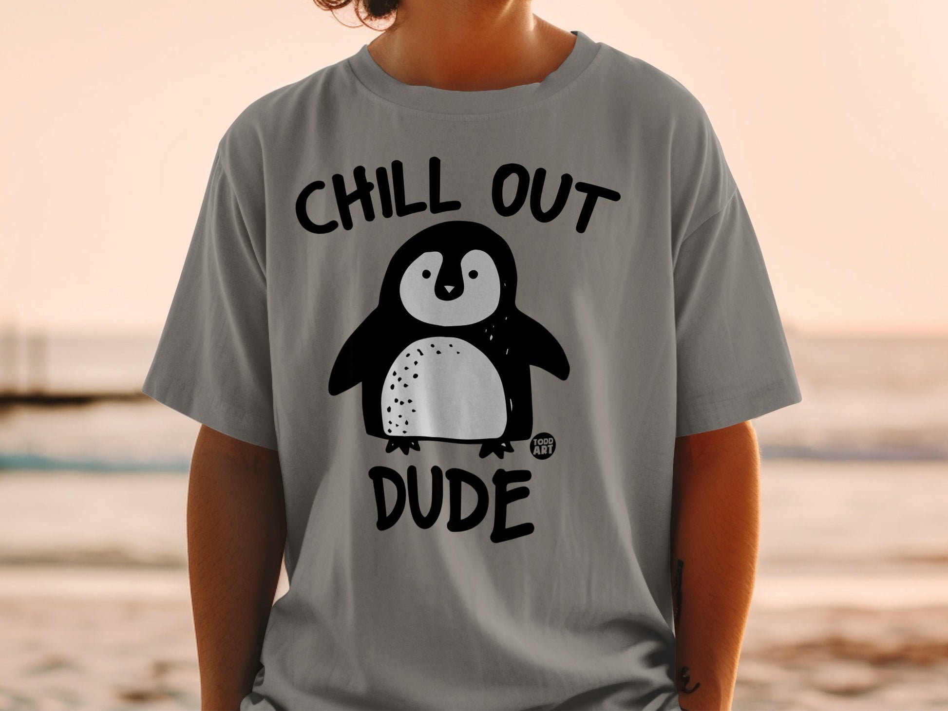 Grey t-shirt with "Chill Out Dude" and a cartoon penguin.