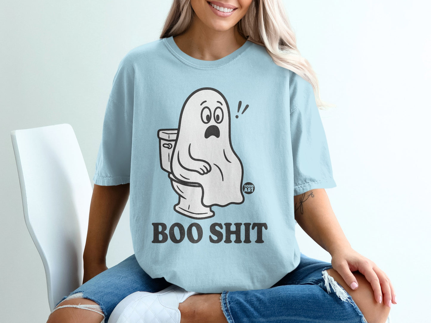 Light blue t-shirt with cartoon ghost sitting on a toilet, text reads "BOO SHIT".