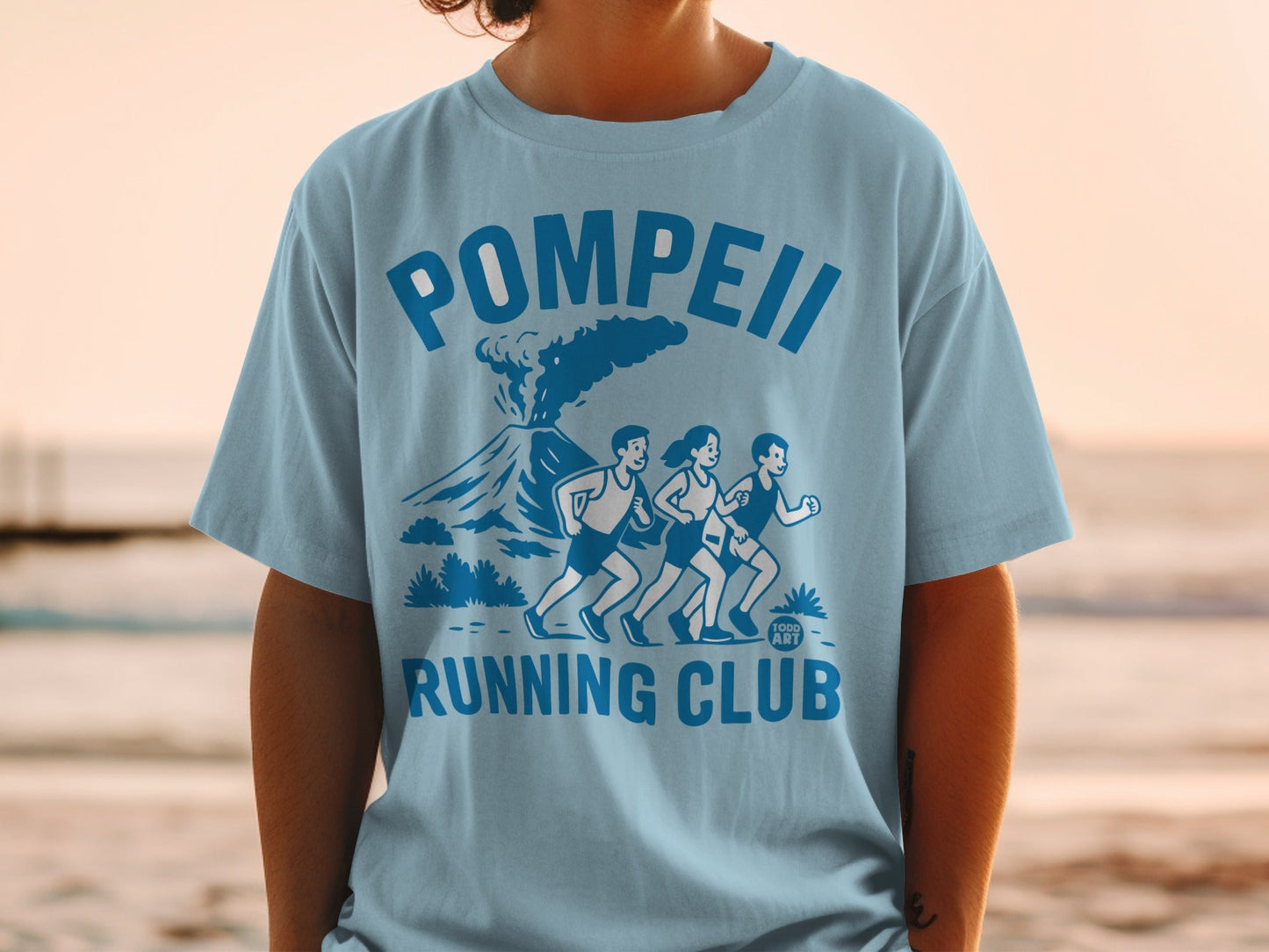 Light blue t-shirt with "Pompeii Running Club" text and volcano graphic.