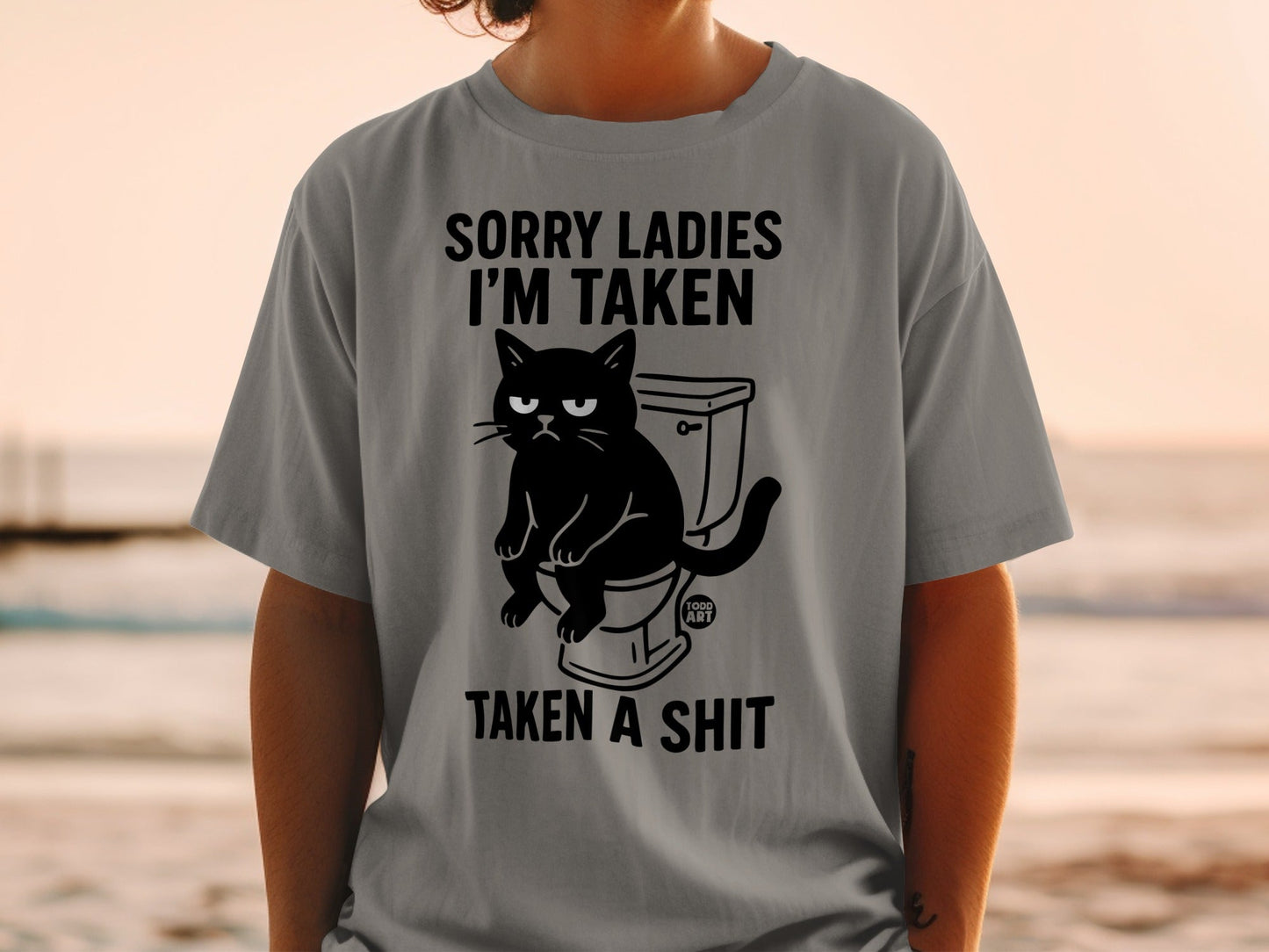 Grey t-shirt with "Sorry Ladies I'm Taken" and a cat on a toilet.