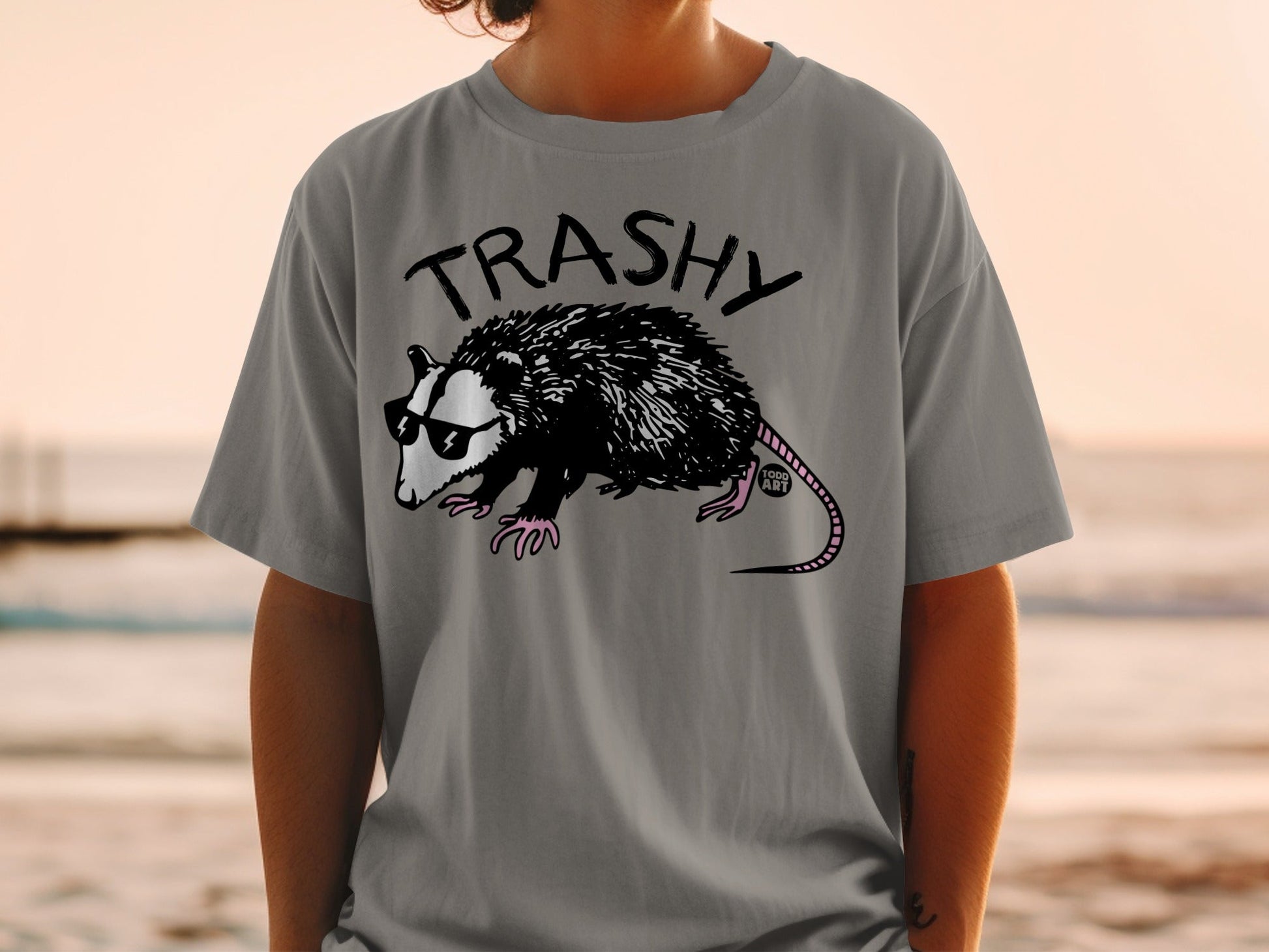 Gray t-shirt with a graphic of a possum wearing sunglasses.