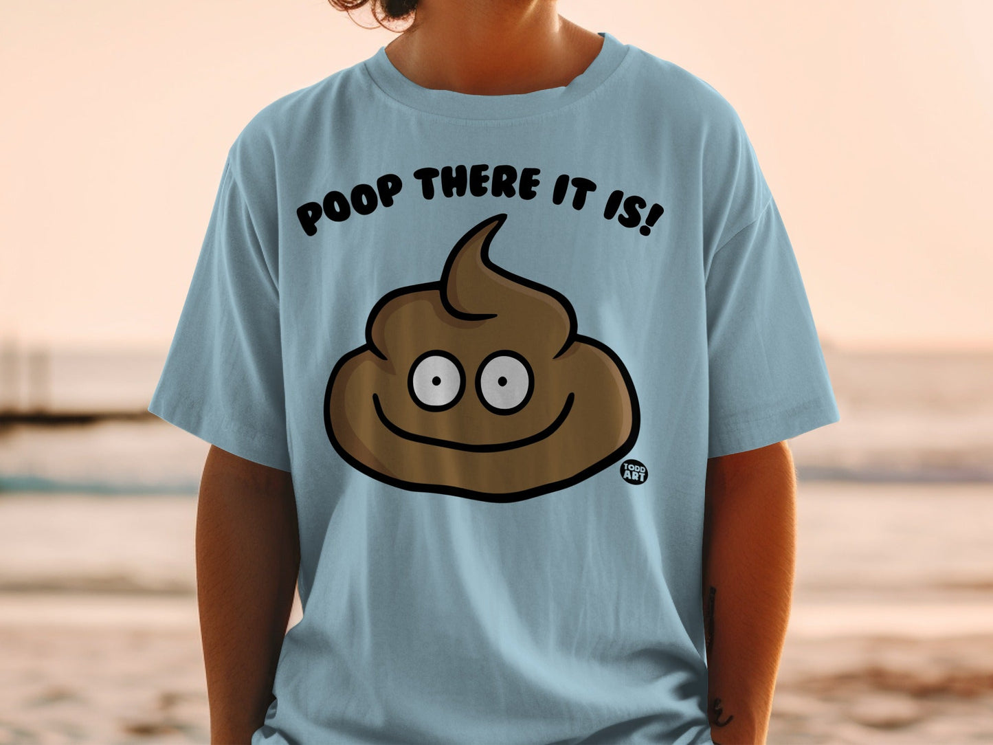 Light blue t-shirt with a smiling poop emoji and text "POOP THERE IT IS!".