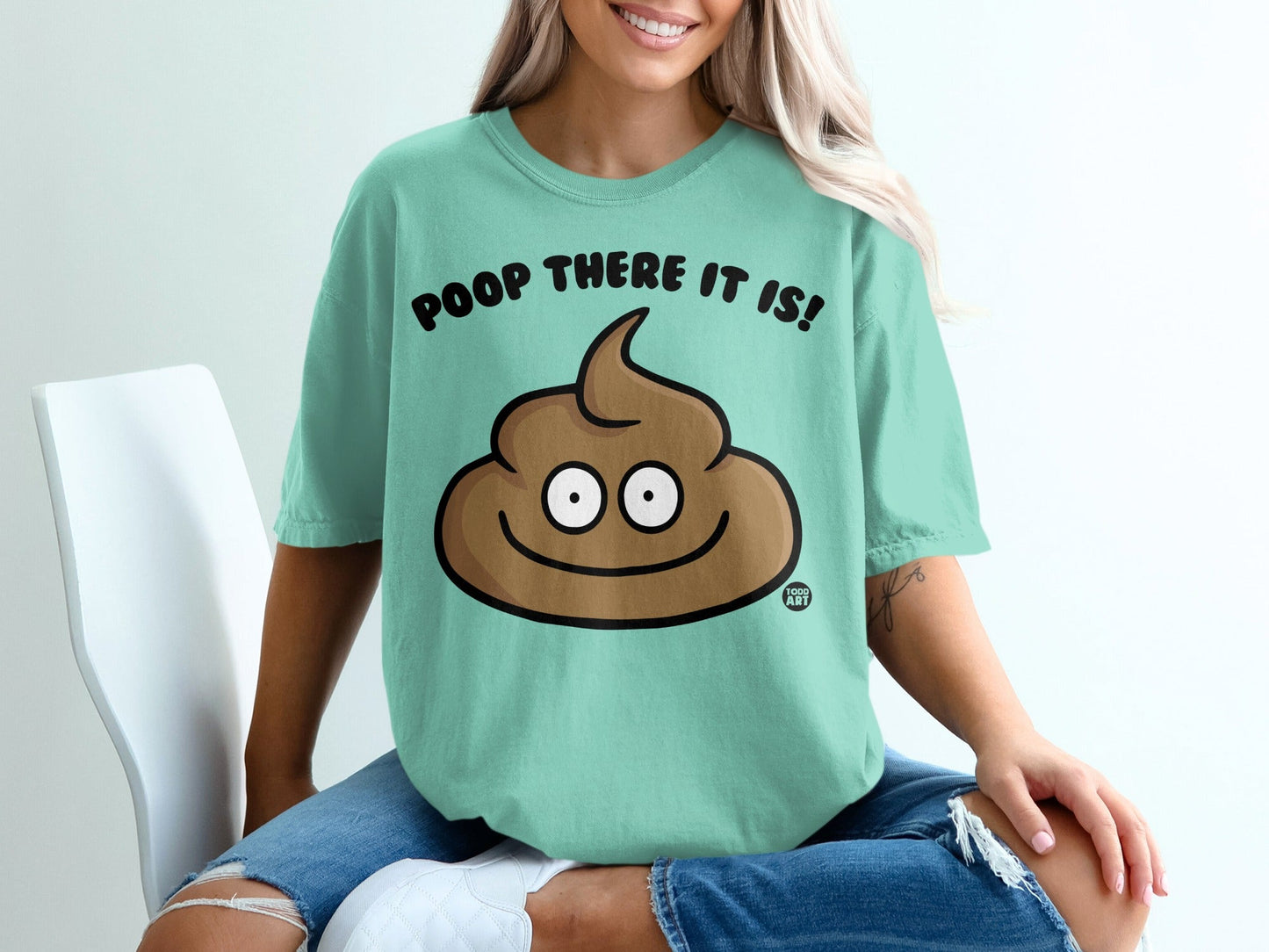 Mint t-shirt with cartoon poop saying "POOP THERE IT IS!"