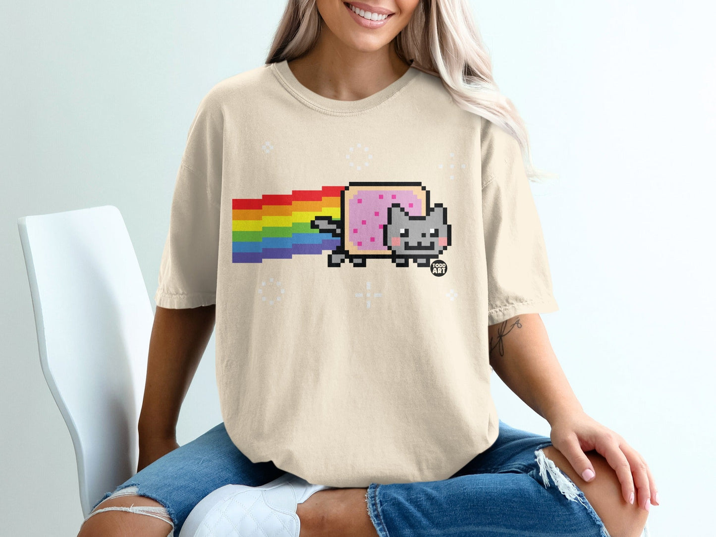 Tan t-shirt featuring a pixelated cat with a rainbow trail, "FOOD ART" text.