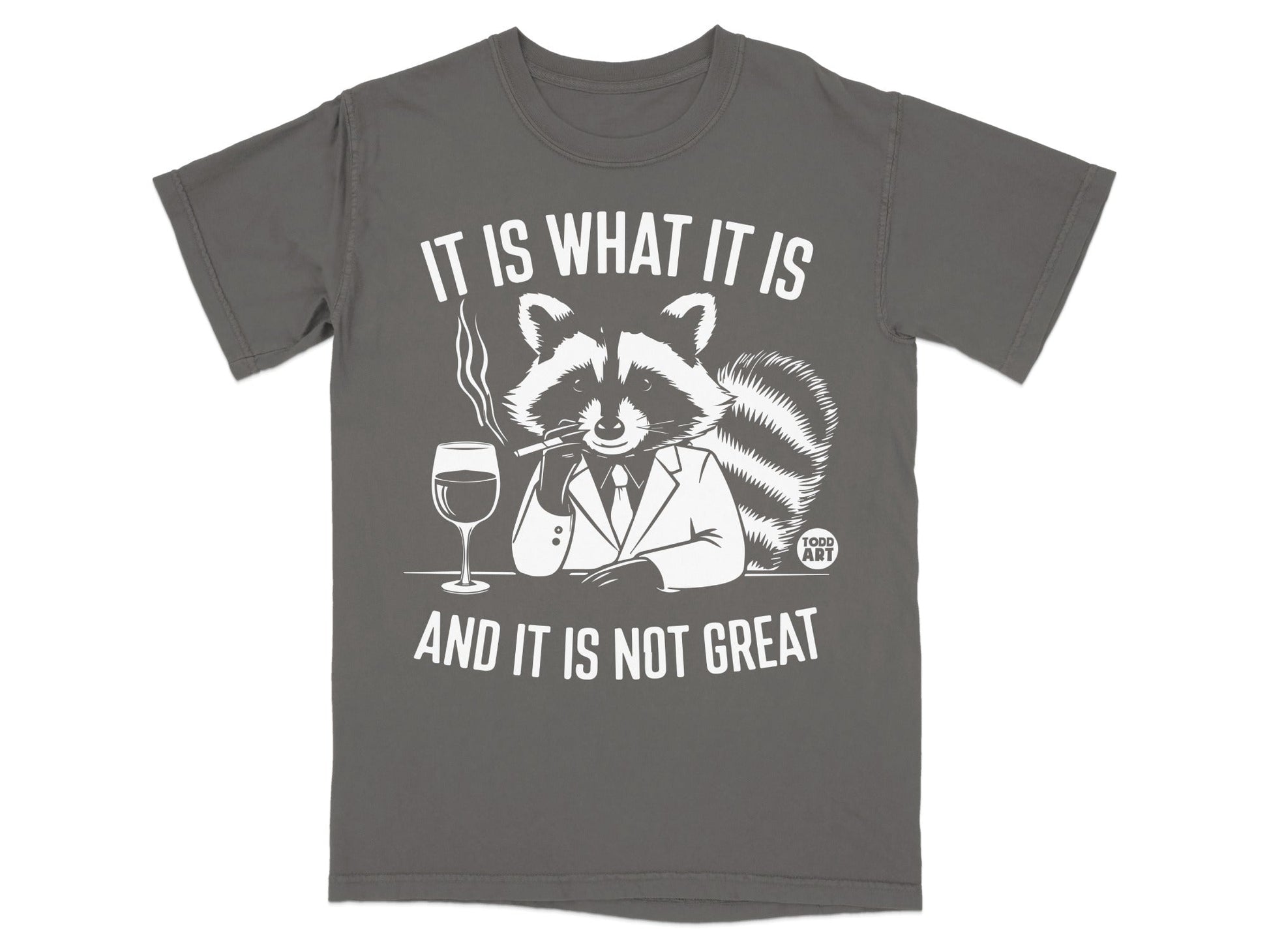 T-shirt with raccoon in suit smoking, drinking wine, text "It is what it is and it is not great".