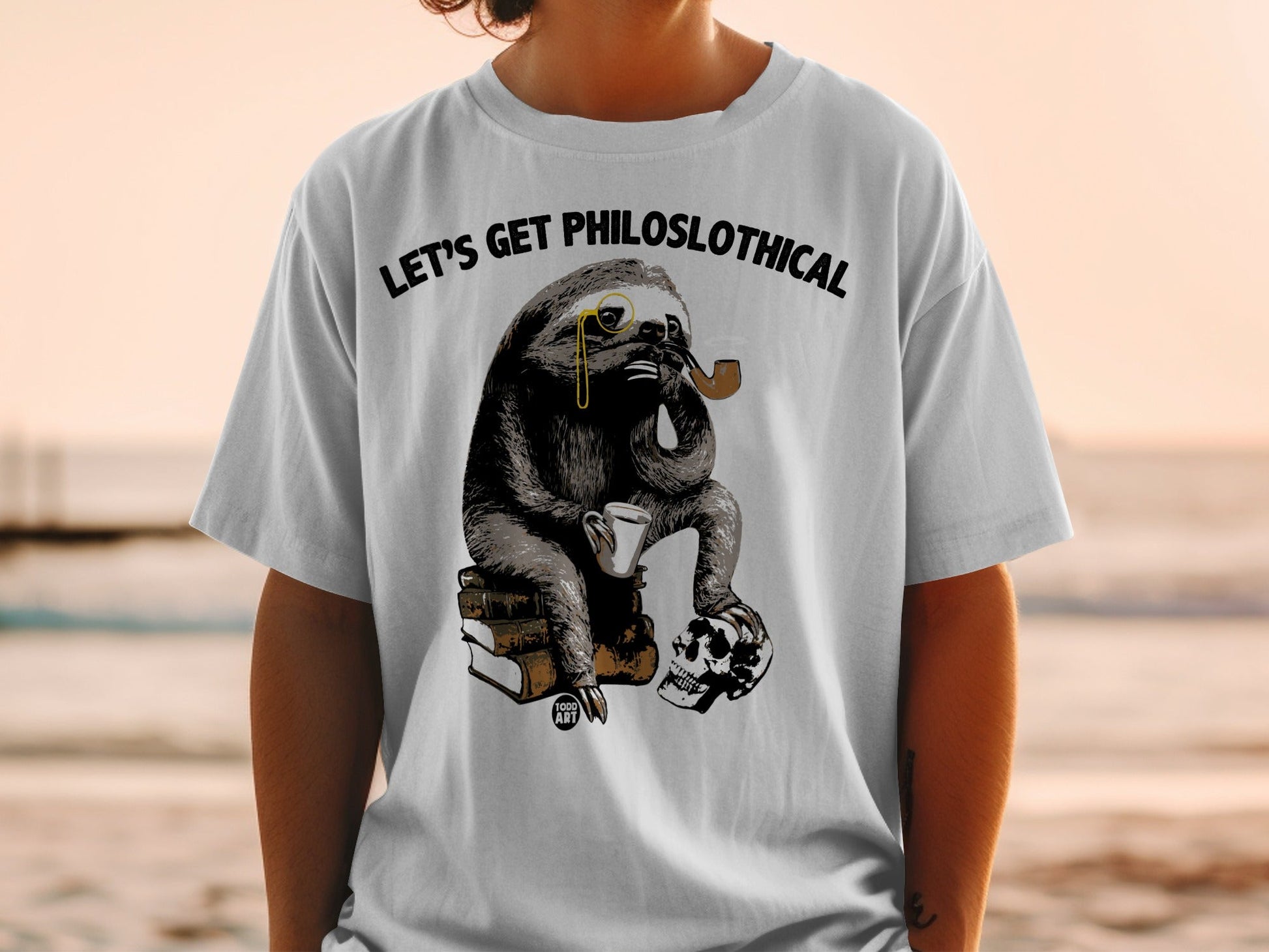 Sloth in shirt smoking pipe on books with skull, "LET'S GET PHILOSOTHLICAL" text.